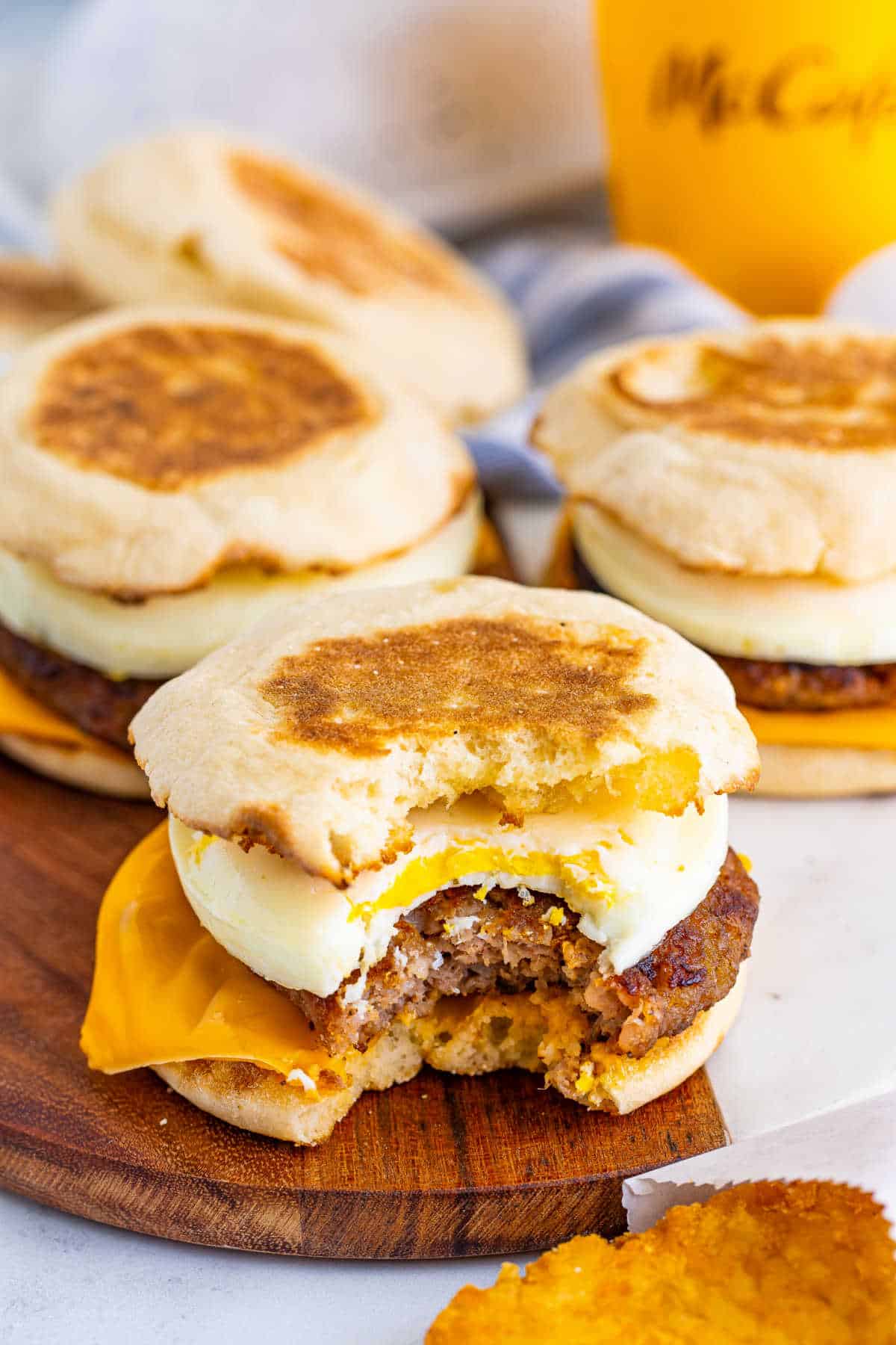 A copycat McDonald's Sausage Egg McMuffin with a bite out of it.