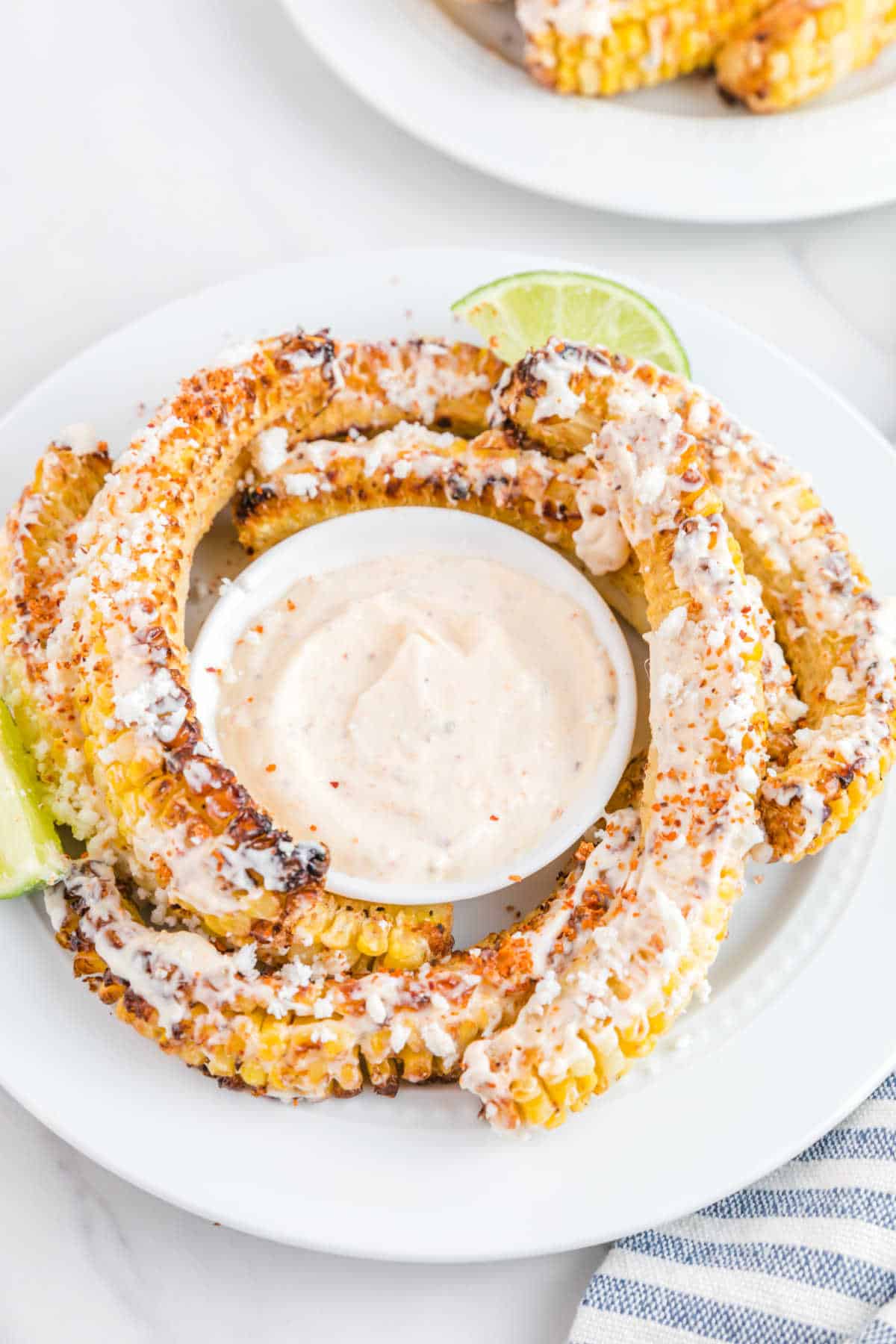 Air fryer corn ribs on a plate with dip.