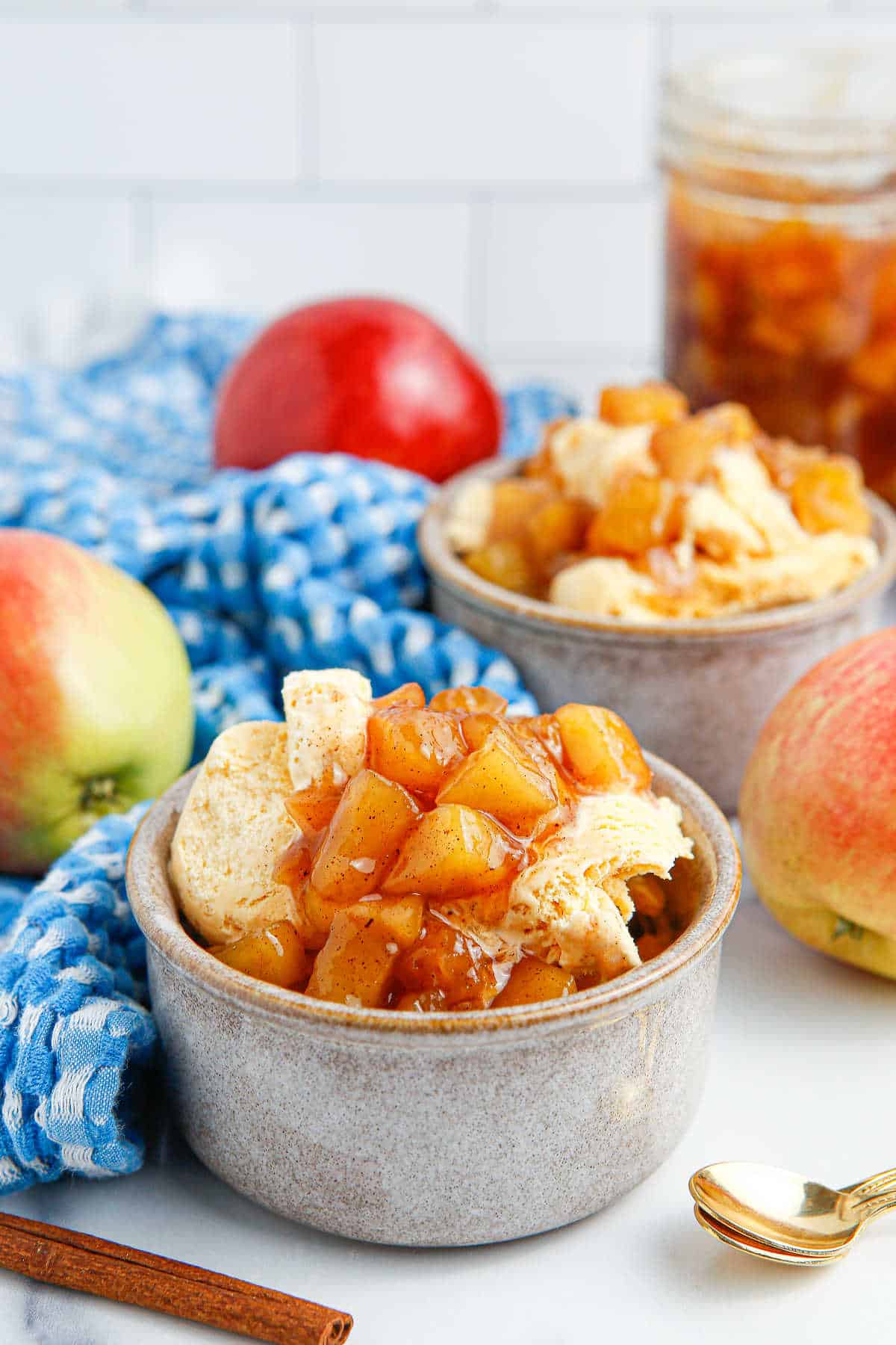 Ice cream in a bowl with apple compote on top.