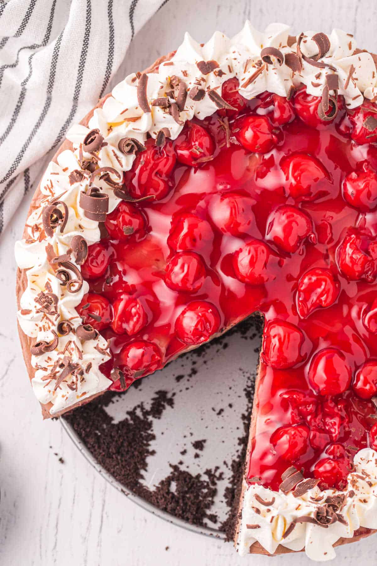A black forest cheesecake with a slice removed.