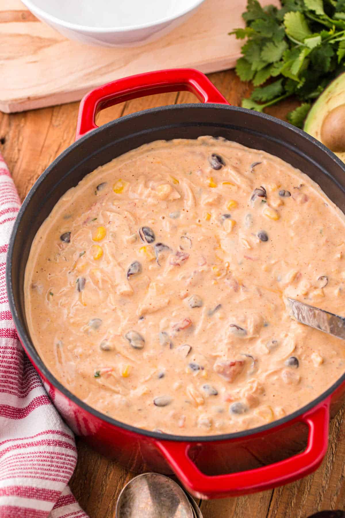 Chicken Enchilada Soup in a pot with a ladle.