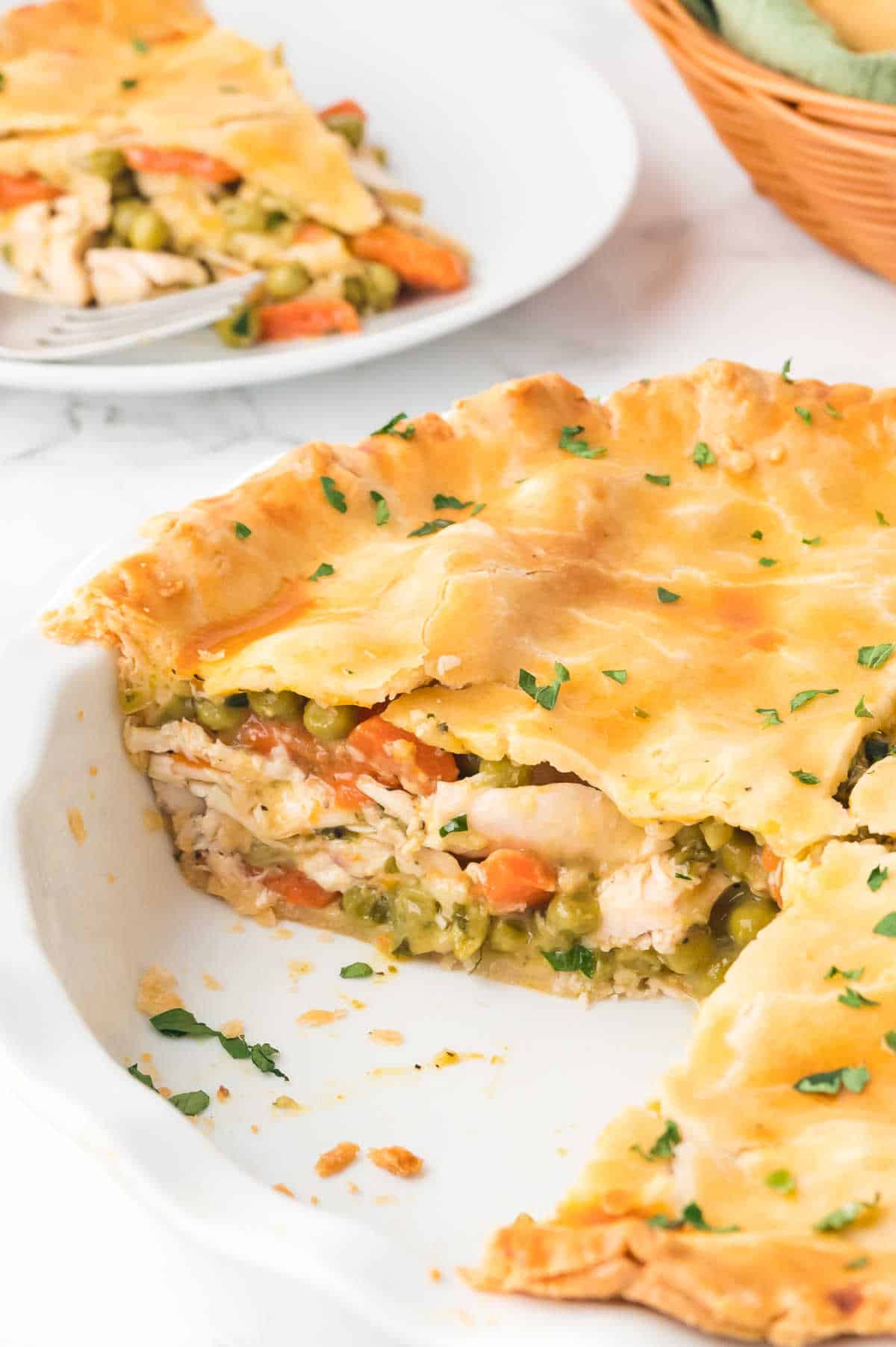 A chicken pot pie with pieces removed.