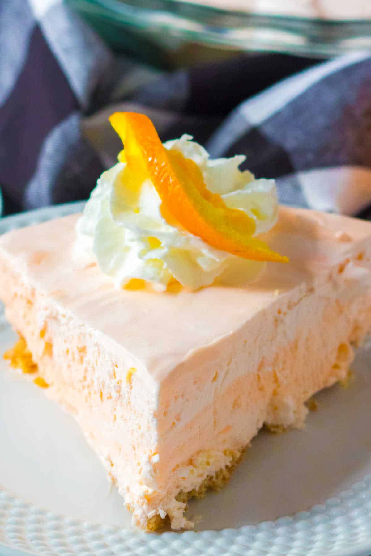 A slice of orange creamsicle pie on a plate.