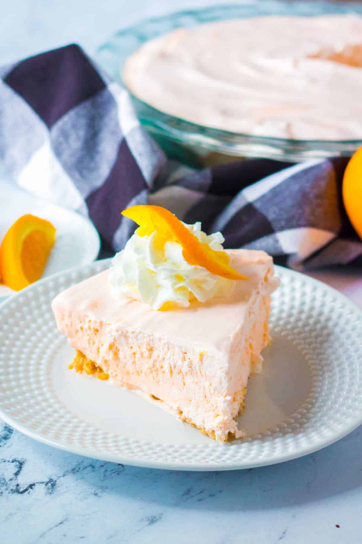 A slice of orange creamsicle pie on a plate.