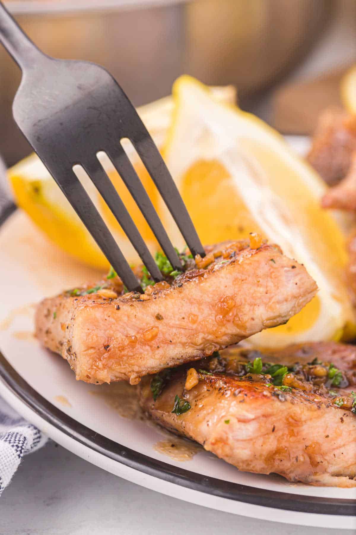 Honey garlic pork chops on a fork.