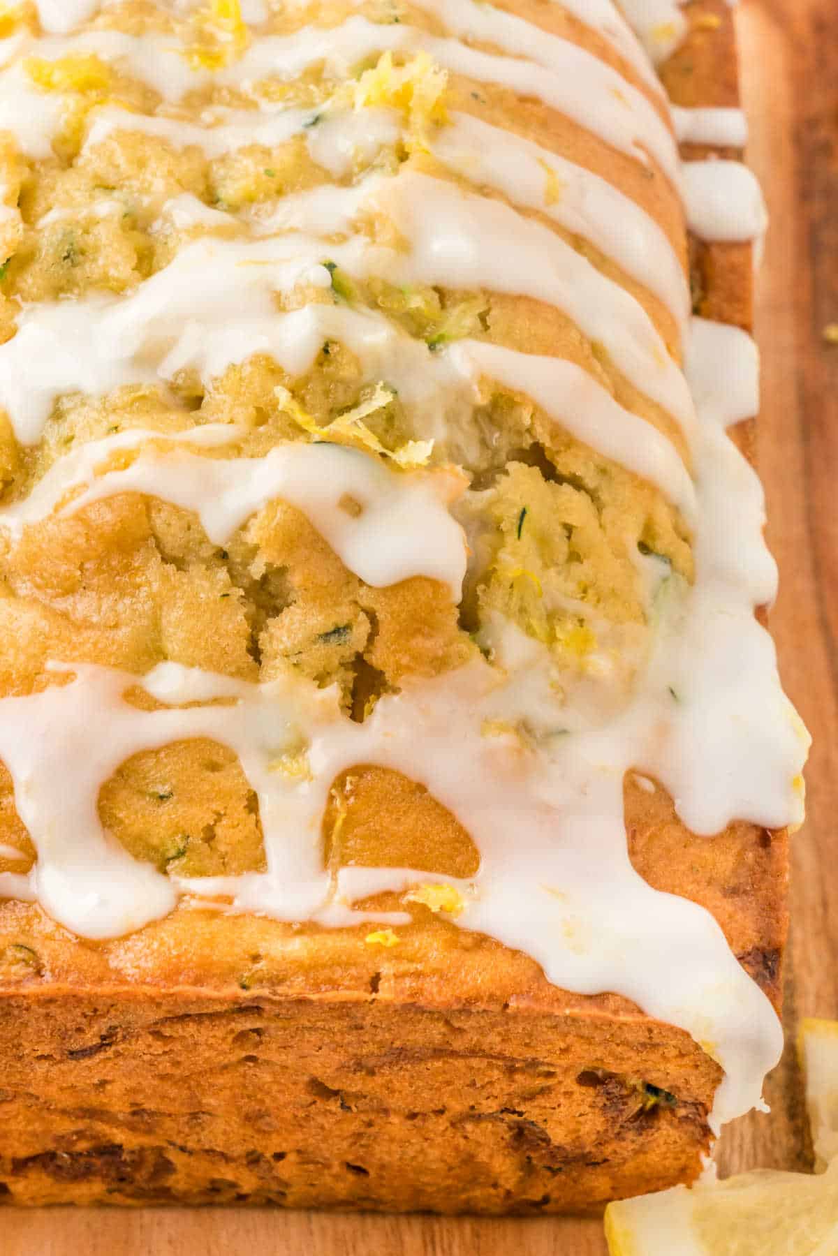 Close up of a loaf of lemon zucchini bread with lemon glaze.