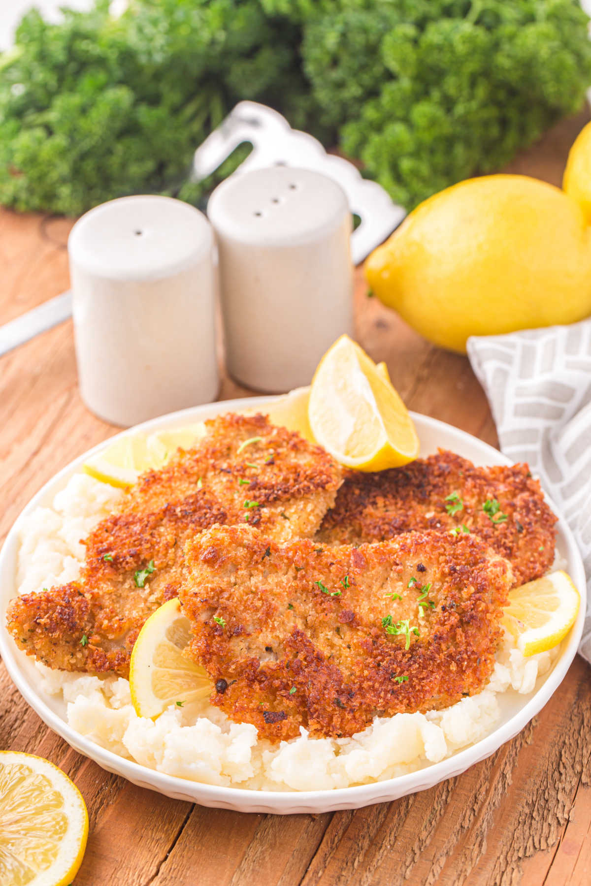 Pork schnitzel on a bed of mashed potatoes.