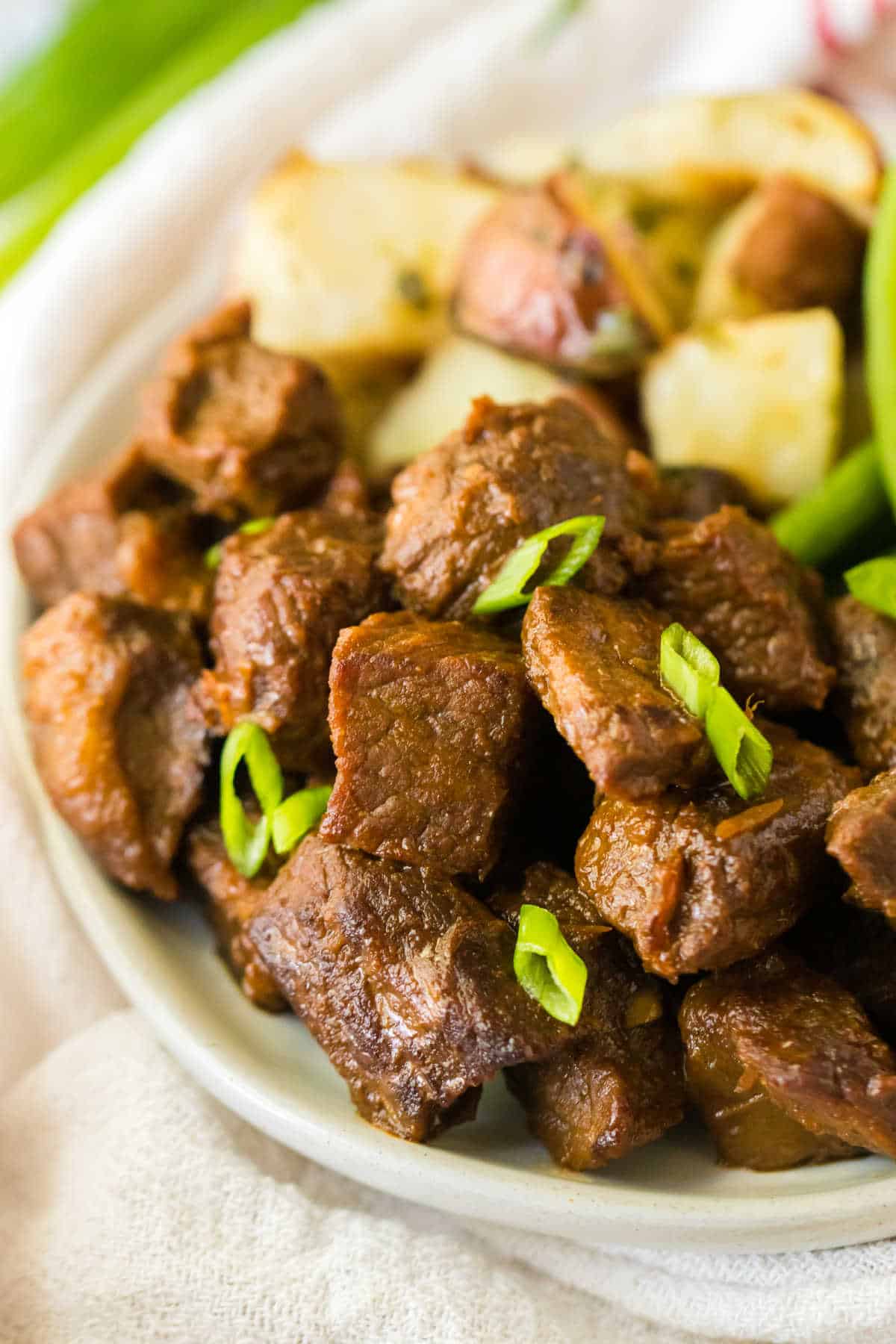 Honey bourbon steak bites on a plate.