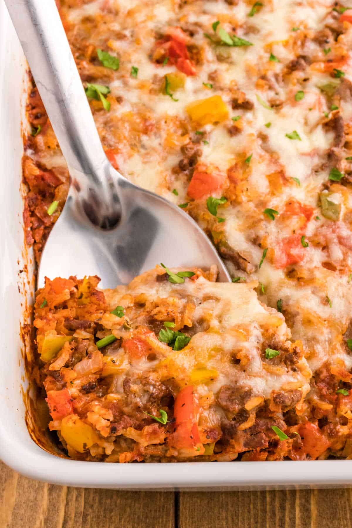 Stuffed pepper casserole with a silver serving spoon.