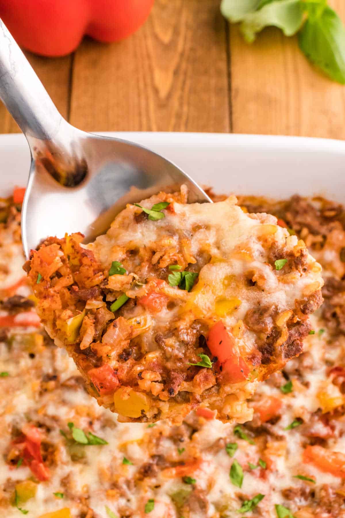 A serving spoon with stuffed pepper casserole.