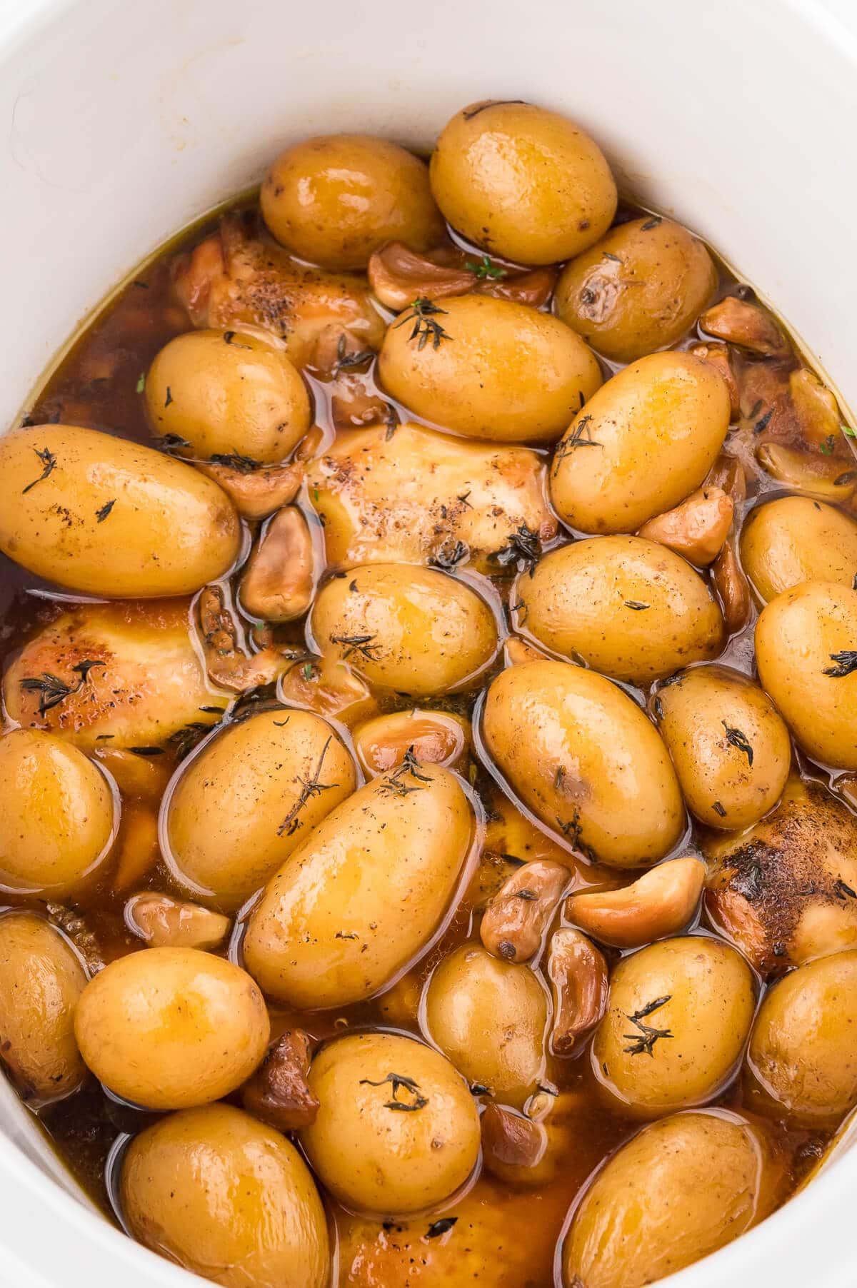 40 clove garlic chicken in a white slow cooker.