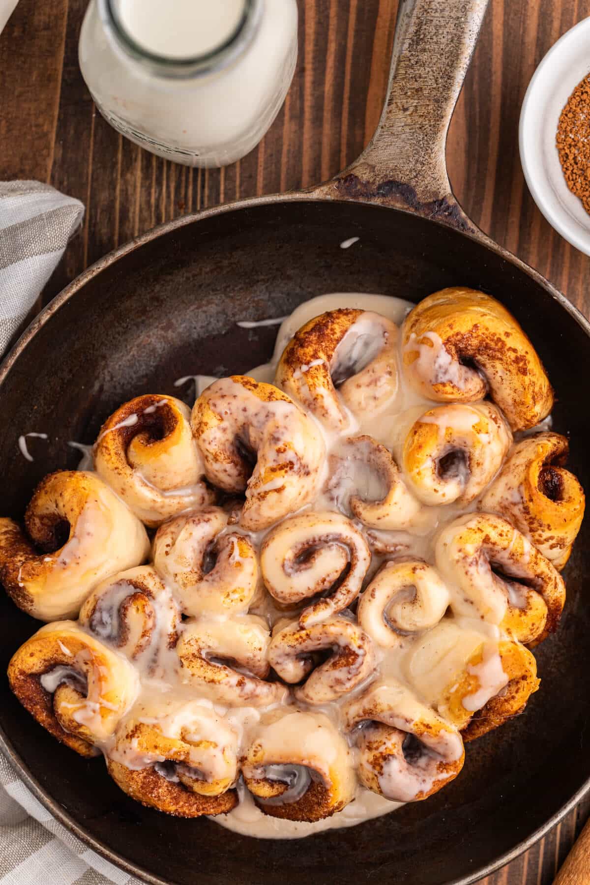 Biscuit cinnamon rolls in a cast iron pan.