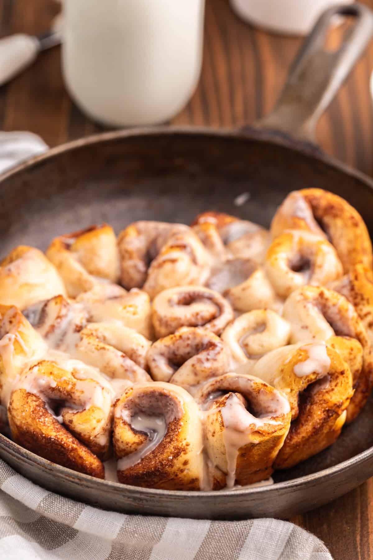 Biscuit cinnamon rolls in a cast iron pan.