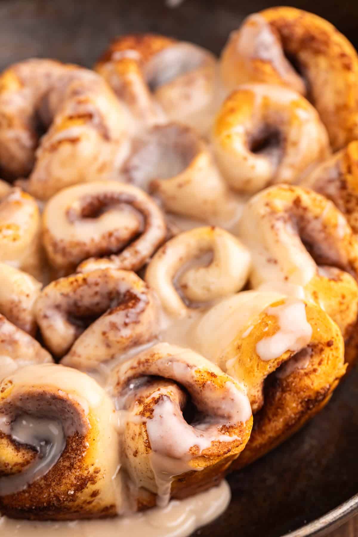 Biscuit cinnamon rolls in a cast iron pan.