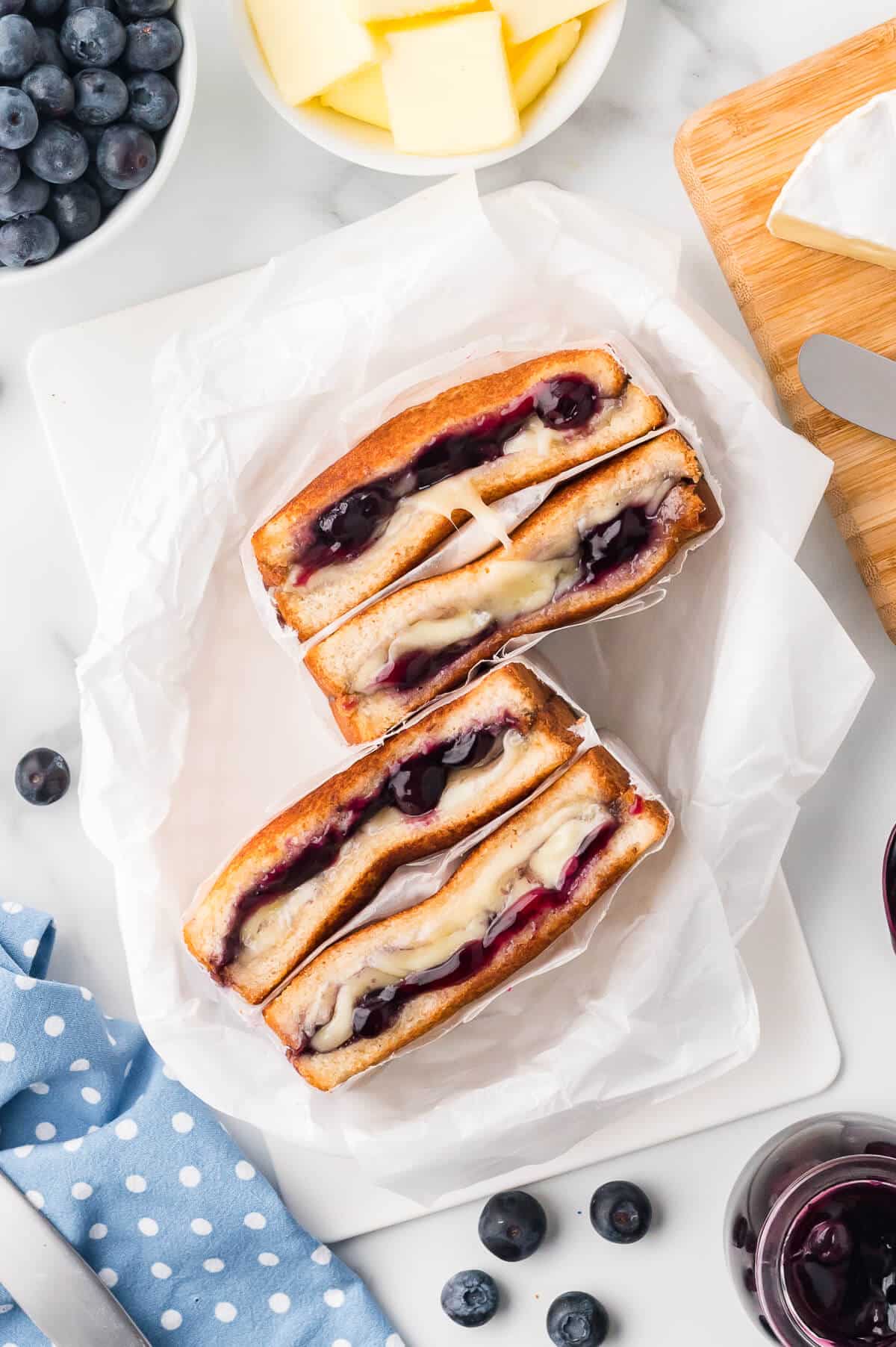 A blueberry brie grilled cheese in parchment paper.