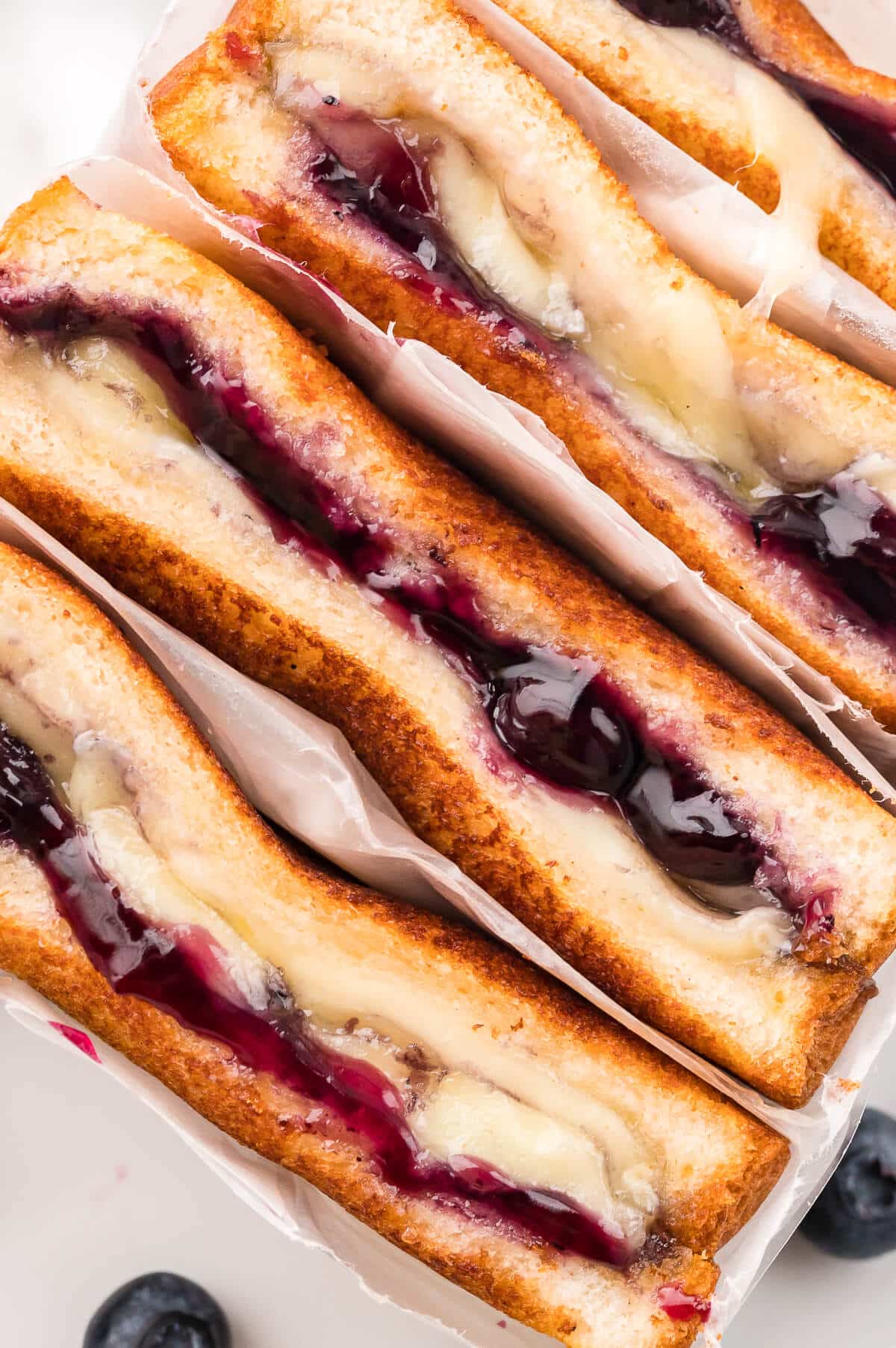 Close up of a blueberry brie grilled cheese sandwich.