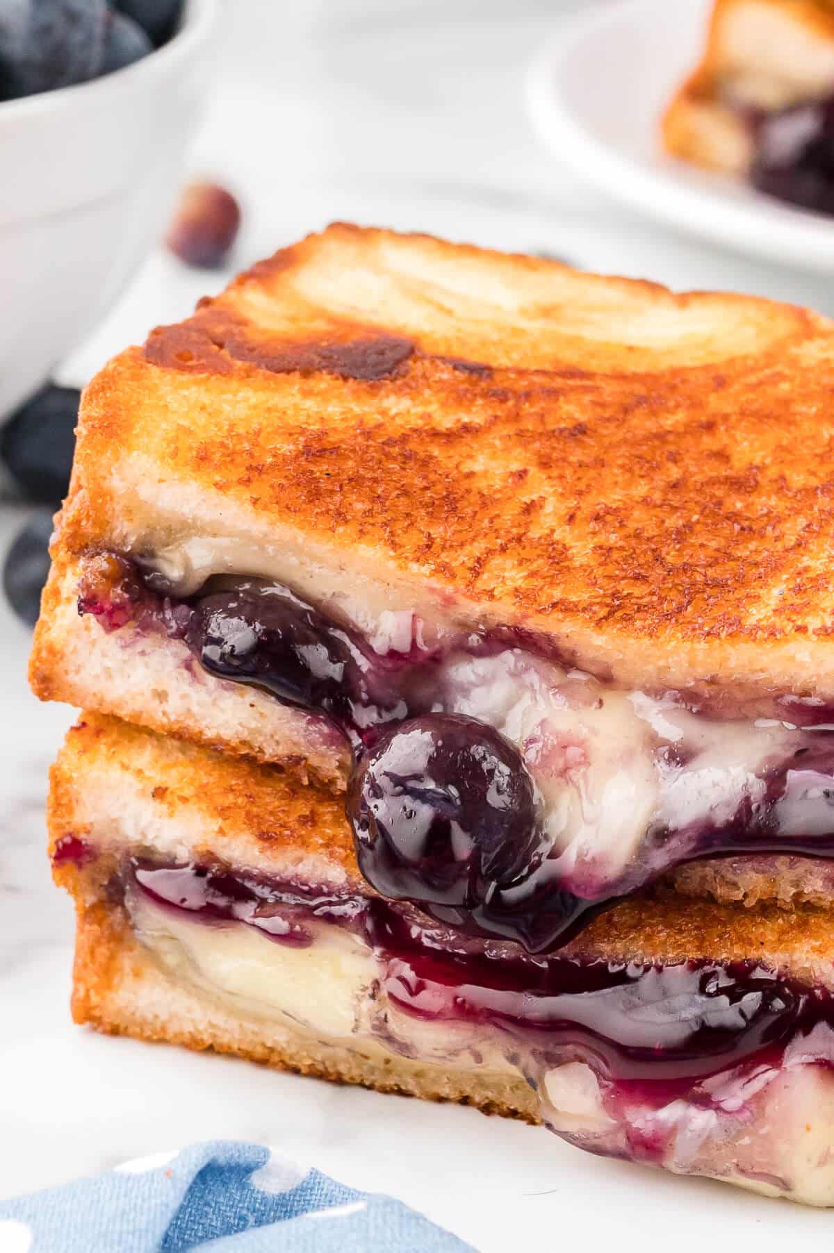 A blueberry brie grilled cheese on a plate.