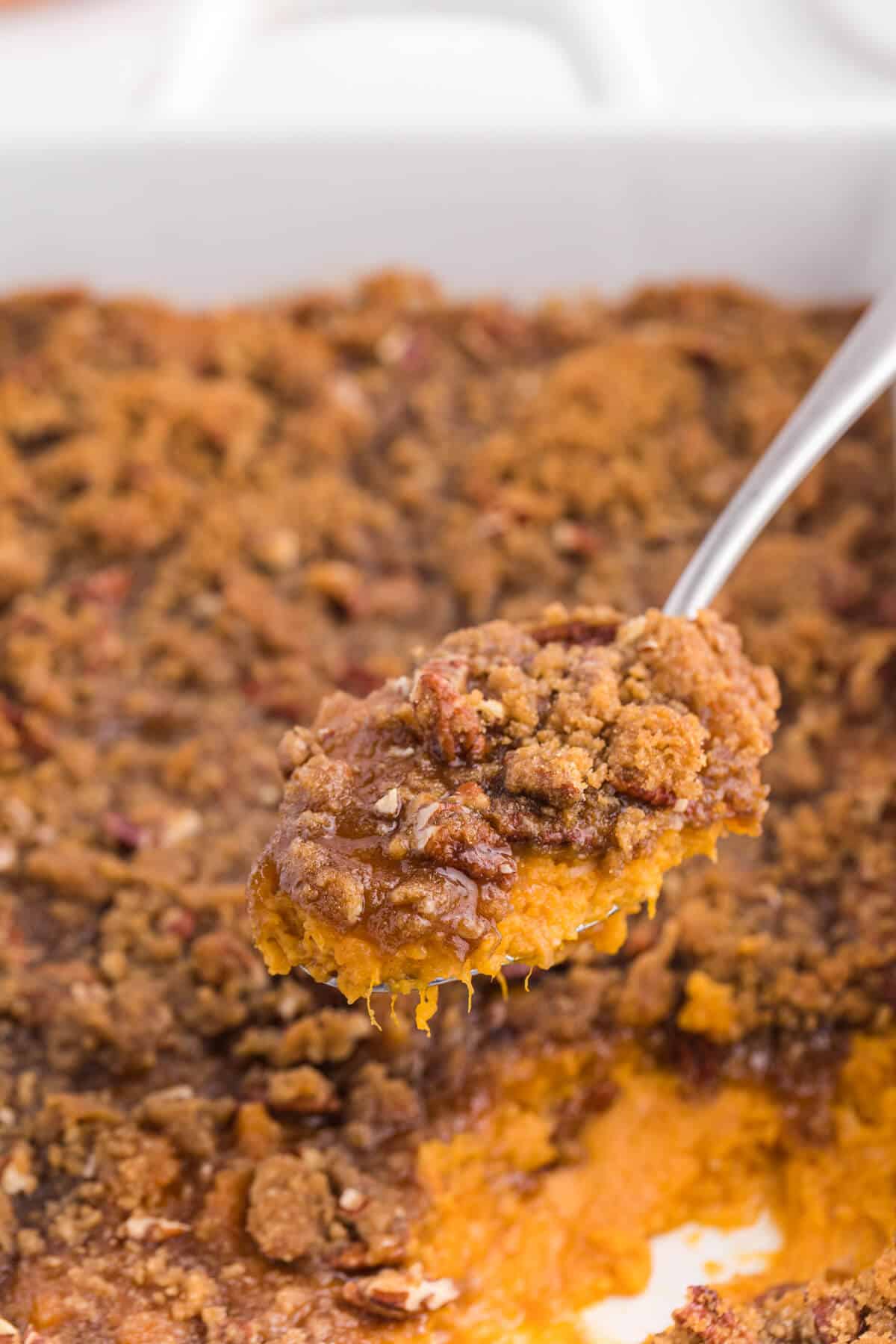 Sweet potato casserole on a serving spoon.