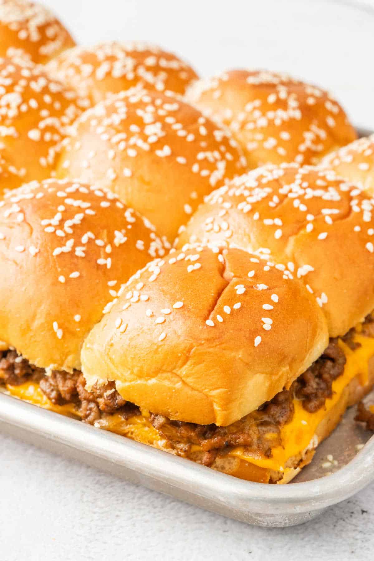 Cheeseburger Sliders on a baking tray.