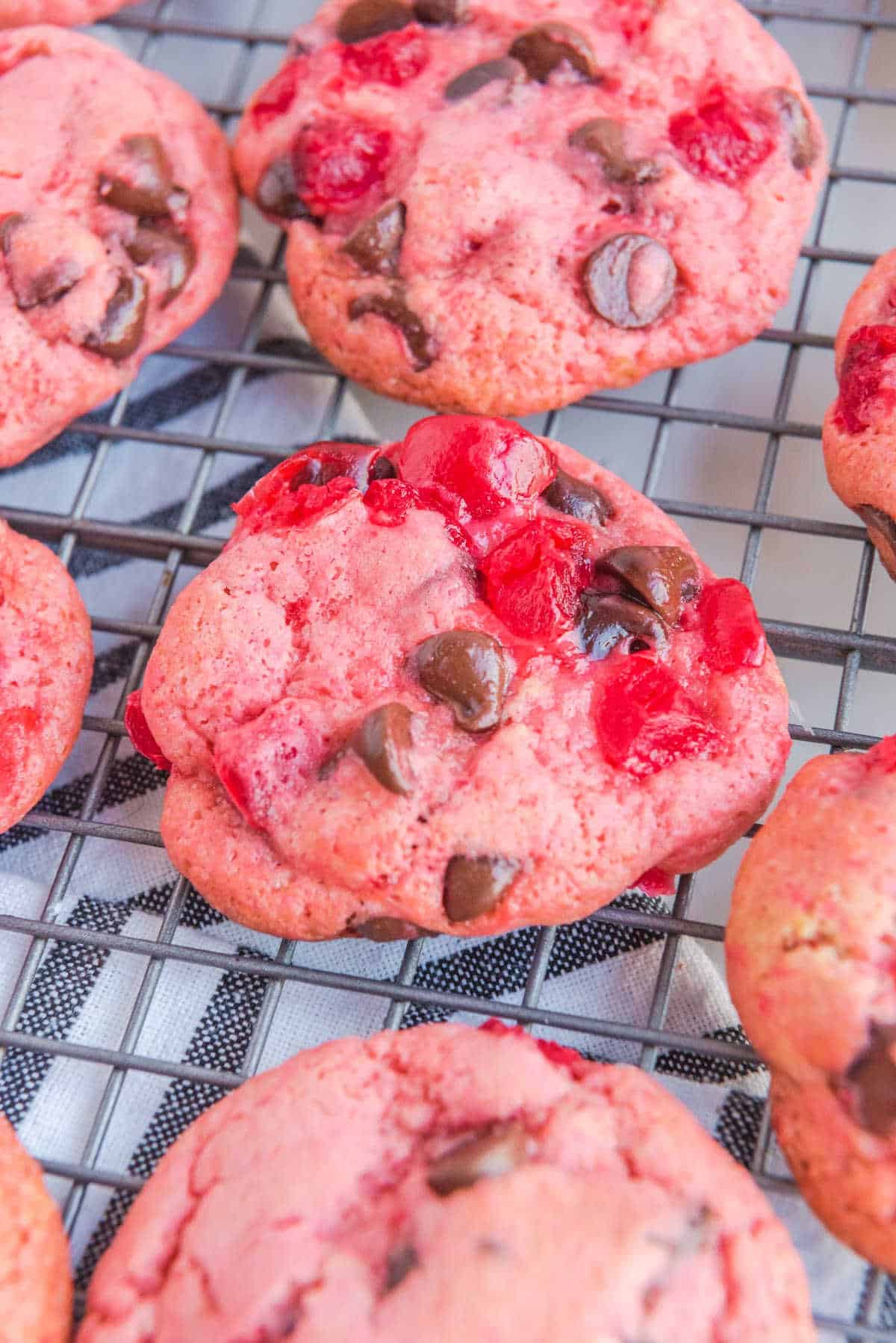 Cherry cookies on a wire rack.