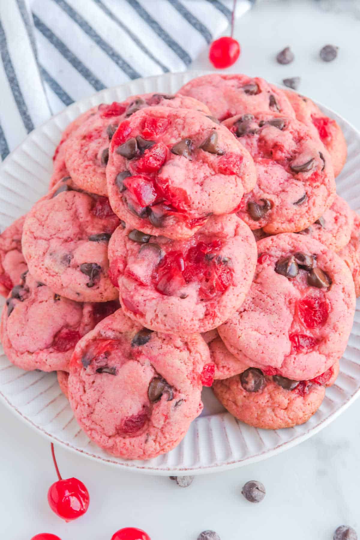 A pile of cherry cookies on a plate.