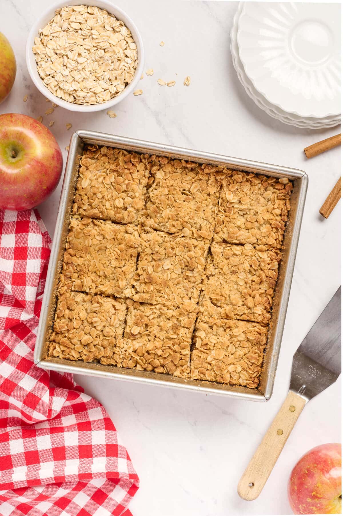 A pan of apple crisp bars with slice cuts.