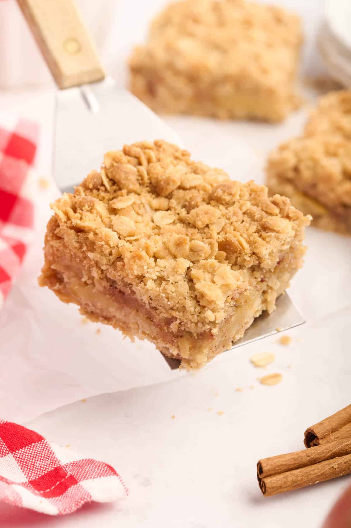 An apple crisp bar on a serving spatula.