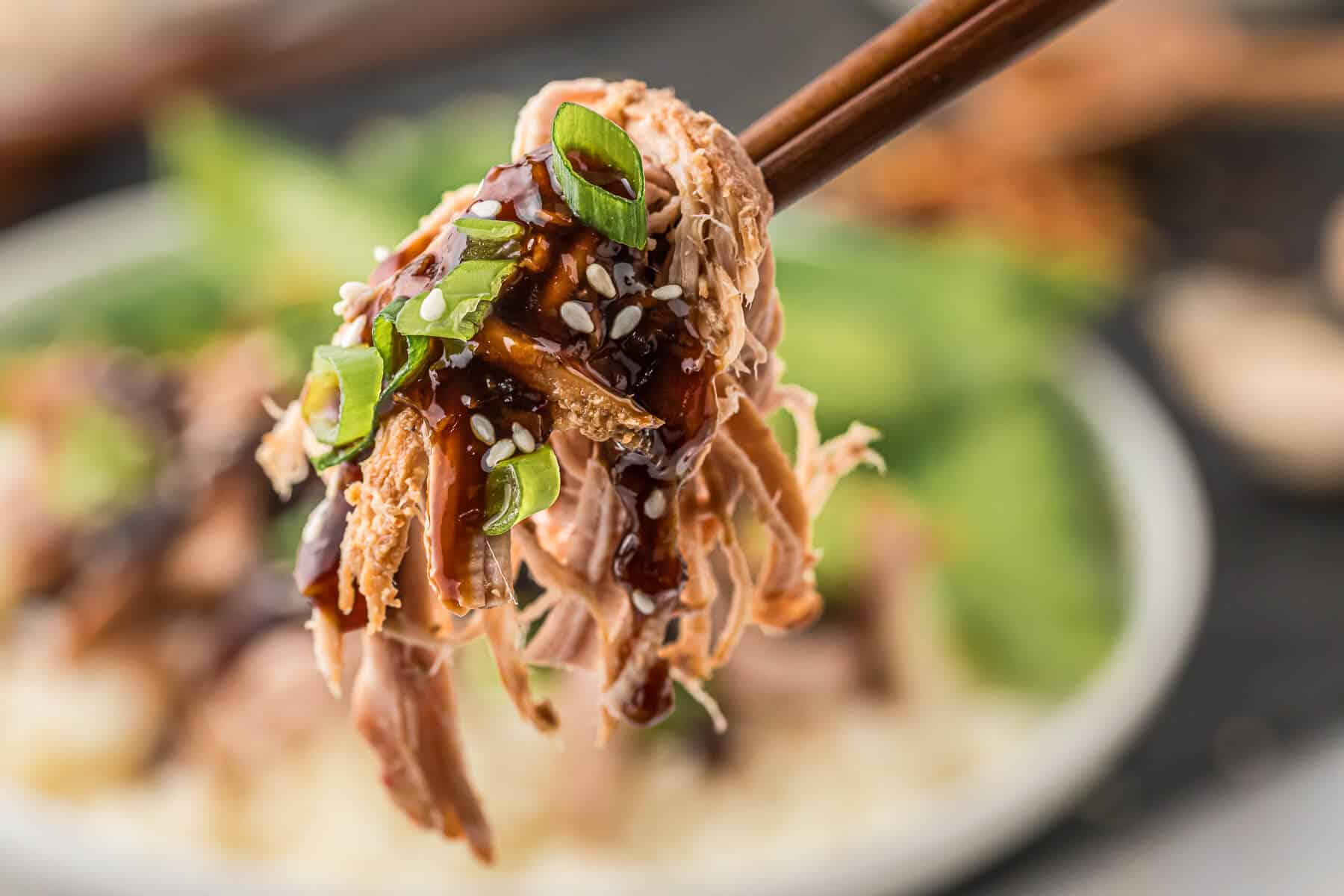 Asian pork tenderloin on wooden chopsticks.