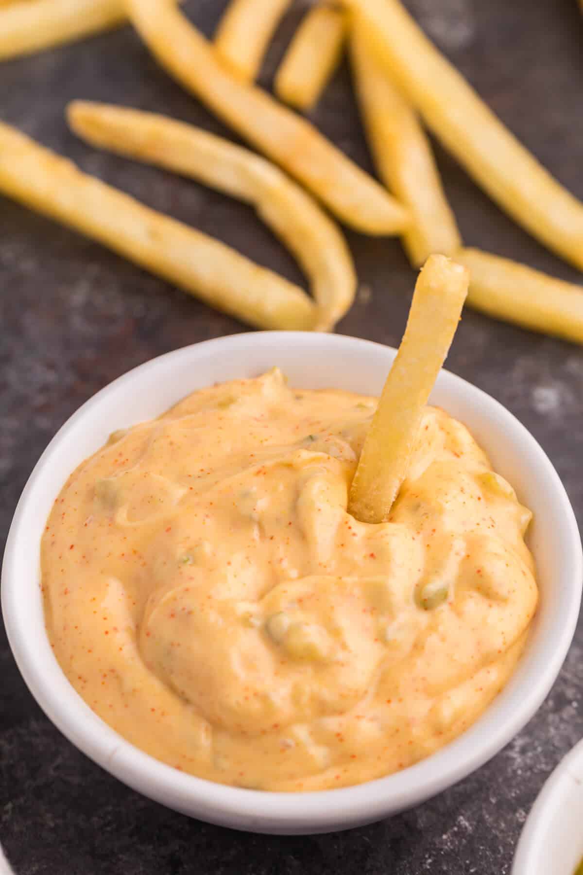 Big mac sauce in a bowl with a French fry in it.