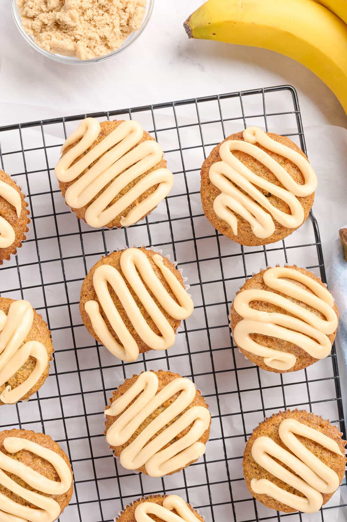 Caramel banana muffins on a wire rack.