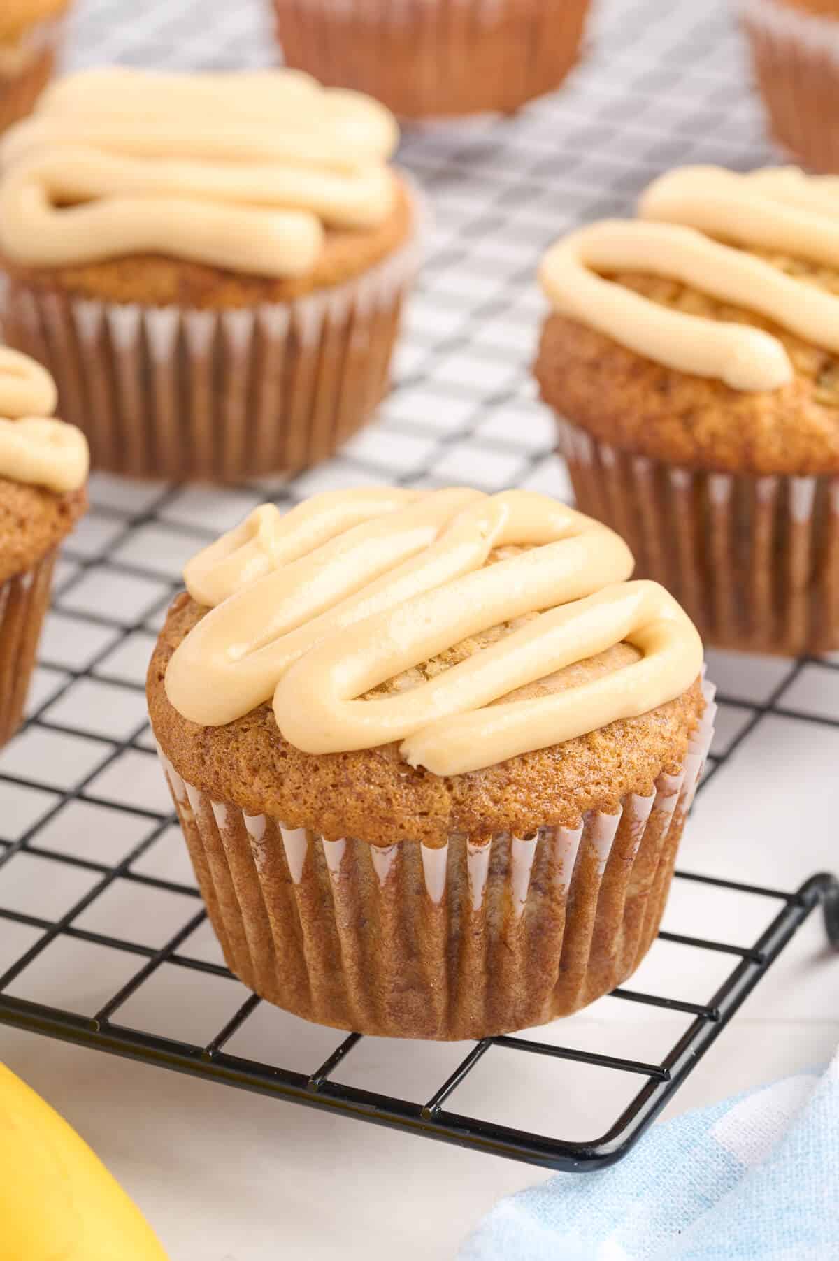 A caramel banana muffin on a wire rack.