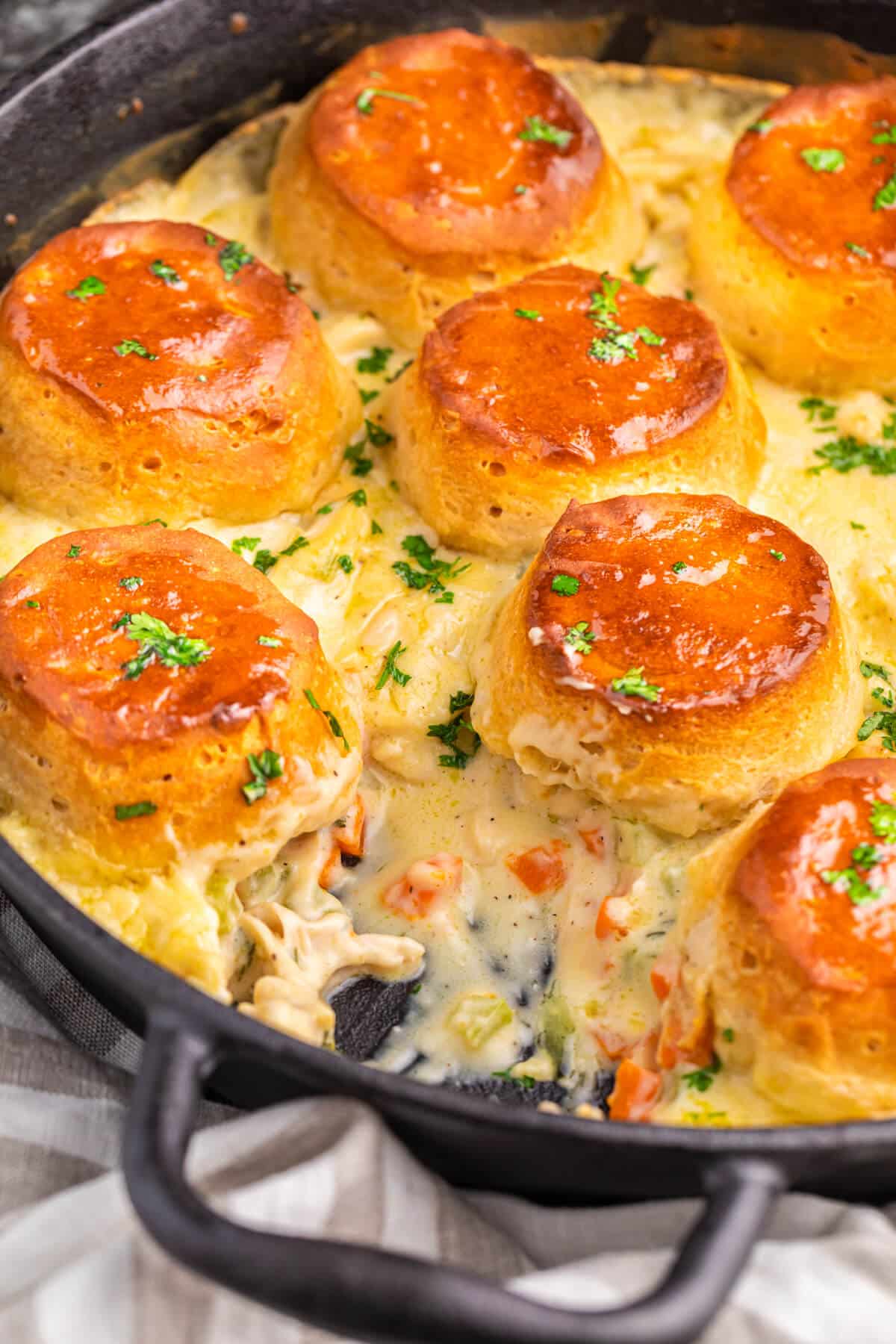 A piece removed from a pan of cast iron skillet chicken pot pie.