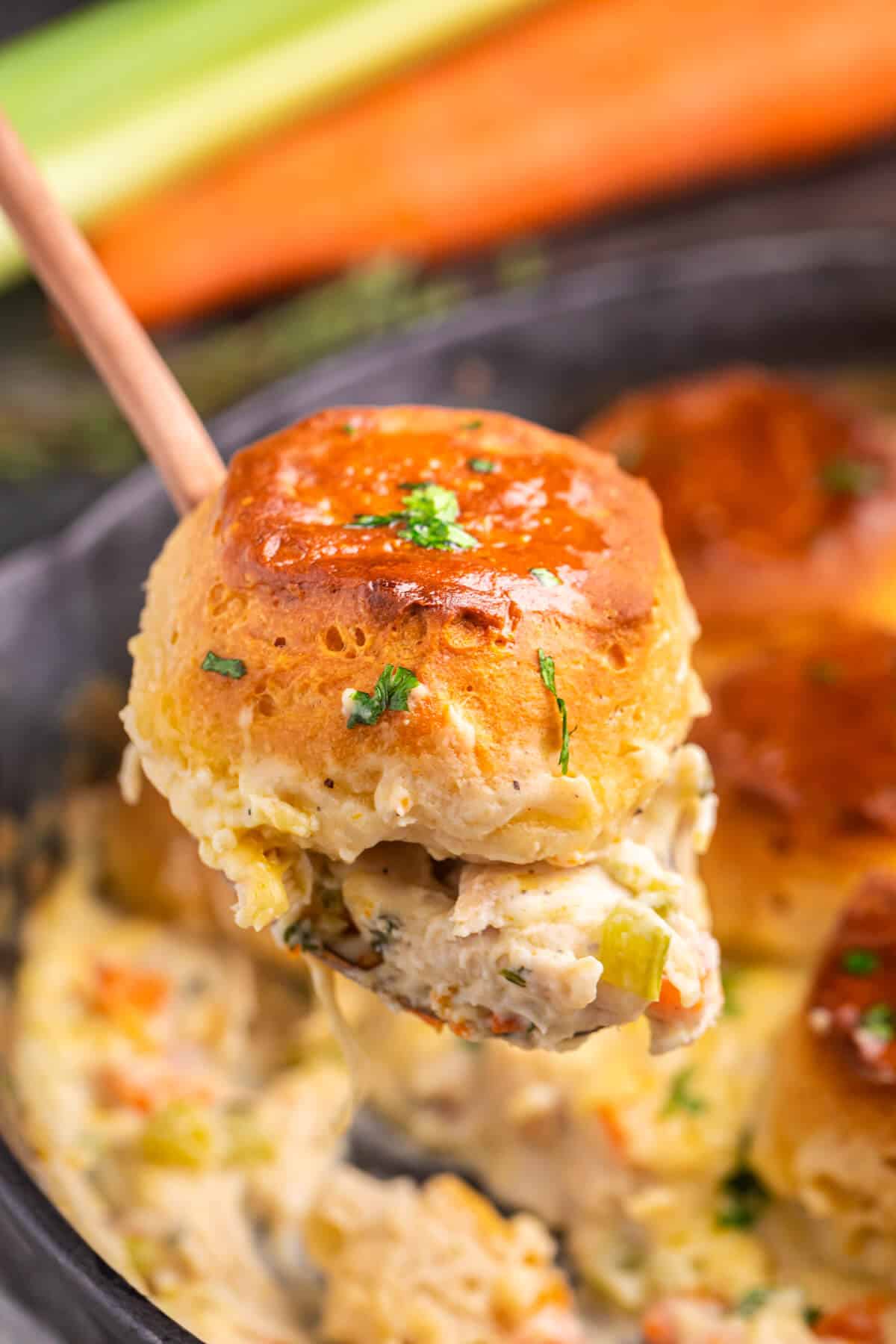 A piece of cast iron skillet chicken pot pie on a serving spoon.