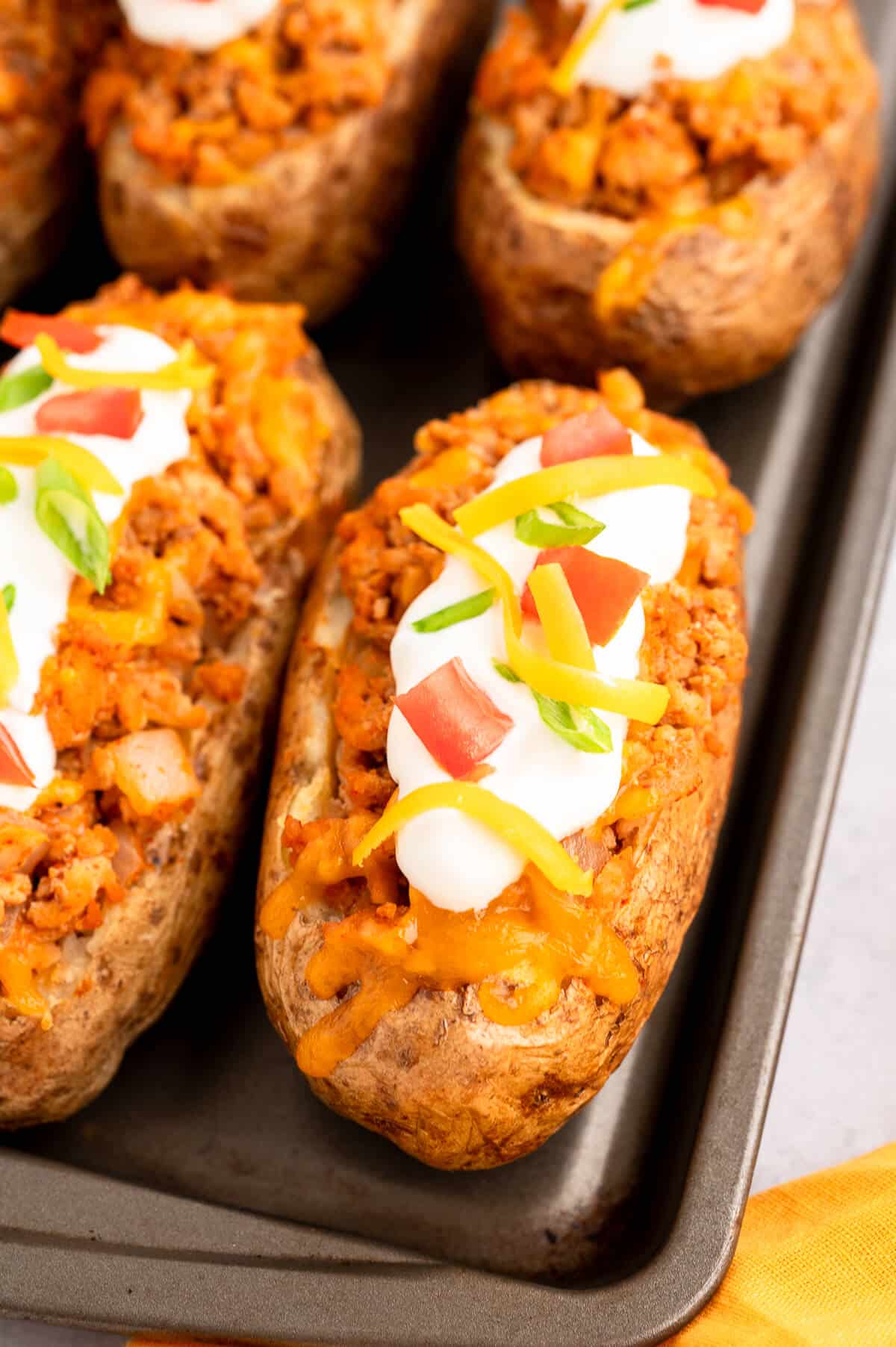 Chicken taco twice-baked potatoes on a baking sheet.