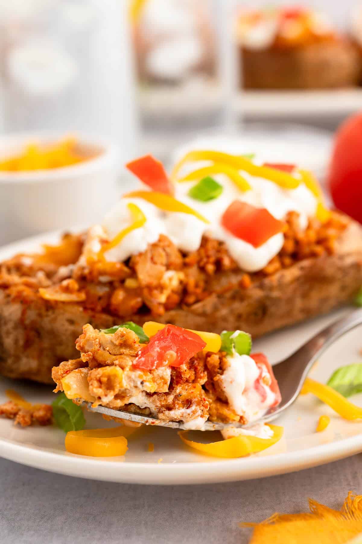 Chicken taco twice-baked potatoes on a fork.