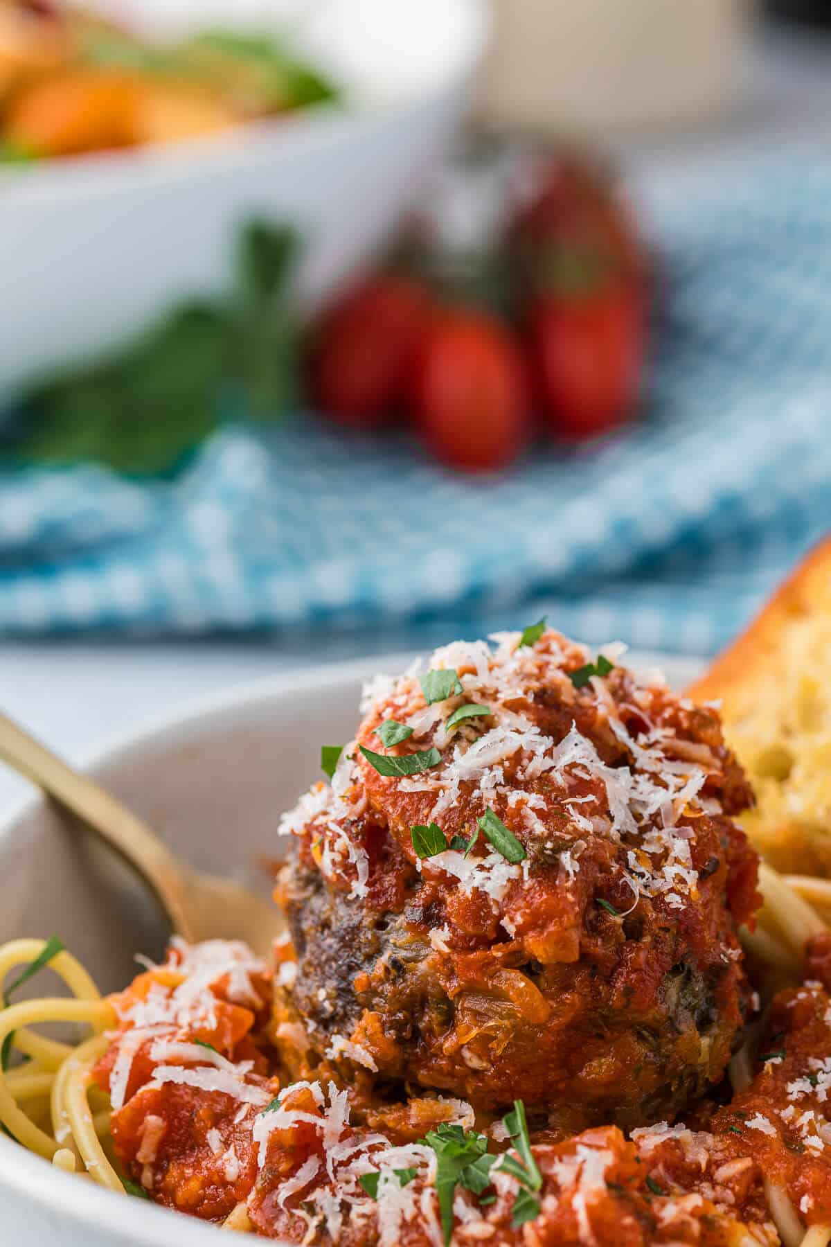 Cheesy meatballs with spaghetti and sauce.
