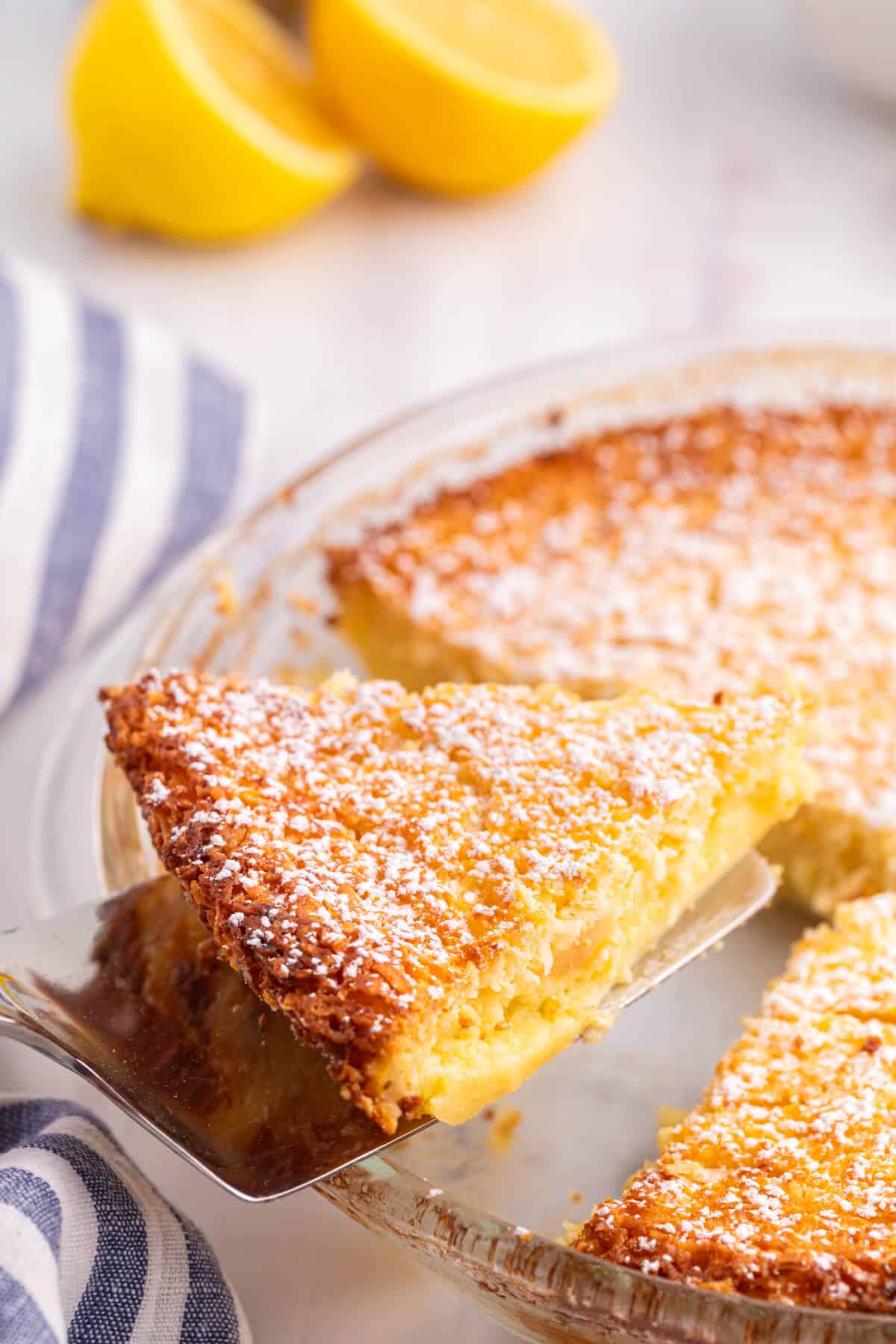 A slice of lemon impossible pie on a spatula.