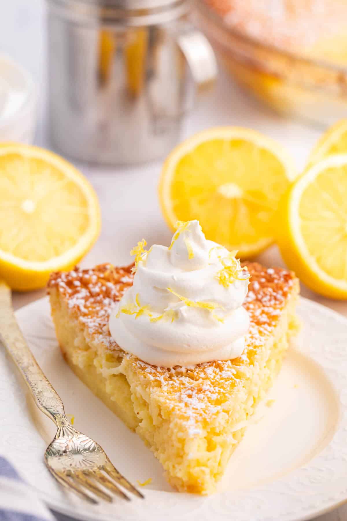 A slice of lemon impossible pie on a plate with a fork.