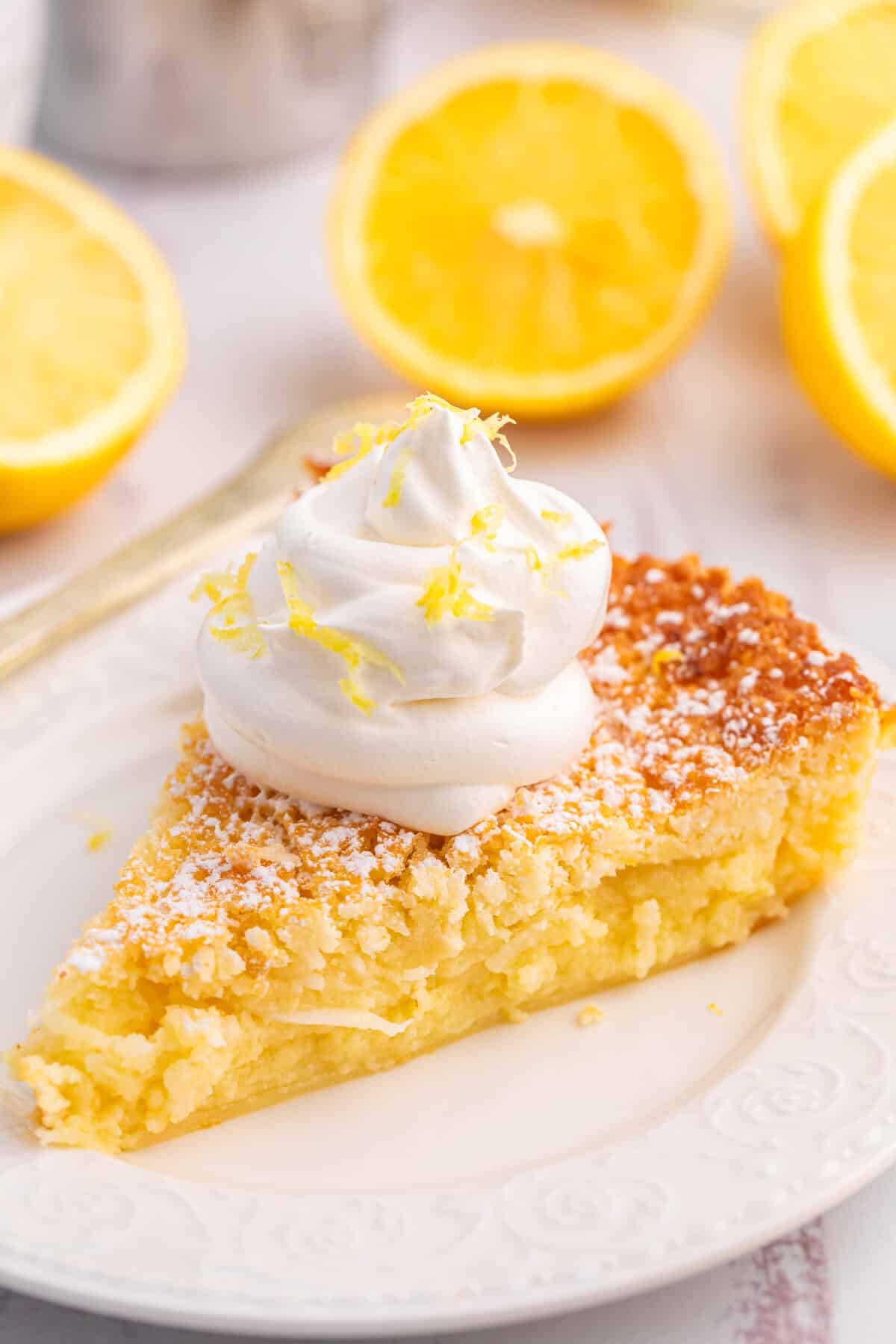 A slice of lemon impossible pie on a plate.