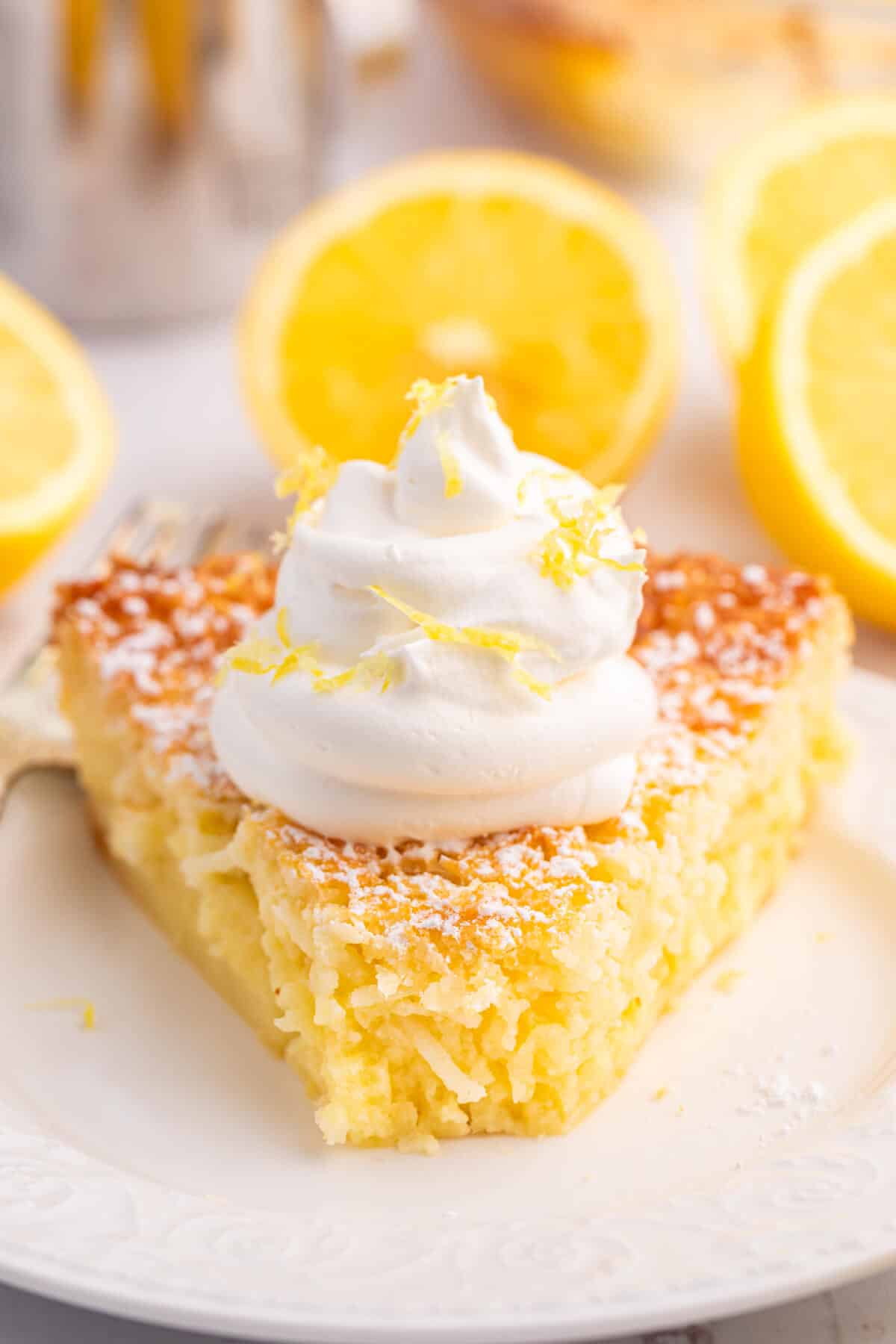 A slice of lemon impossible pie on a plate.