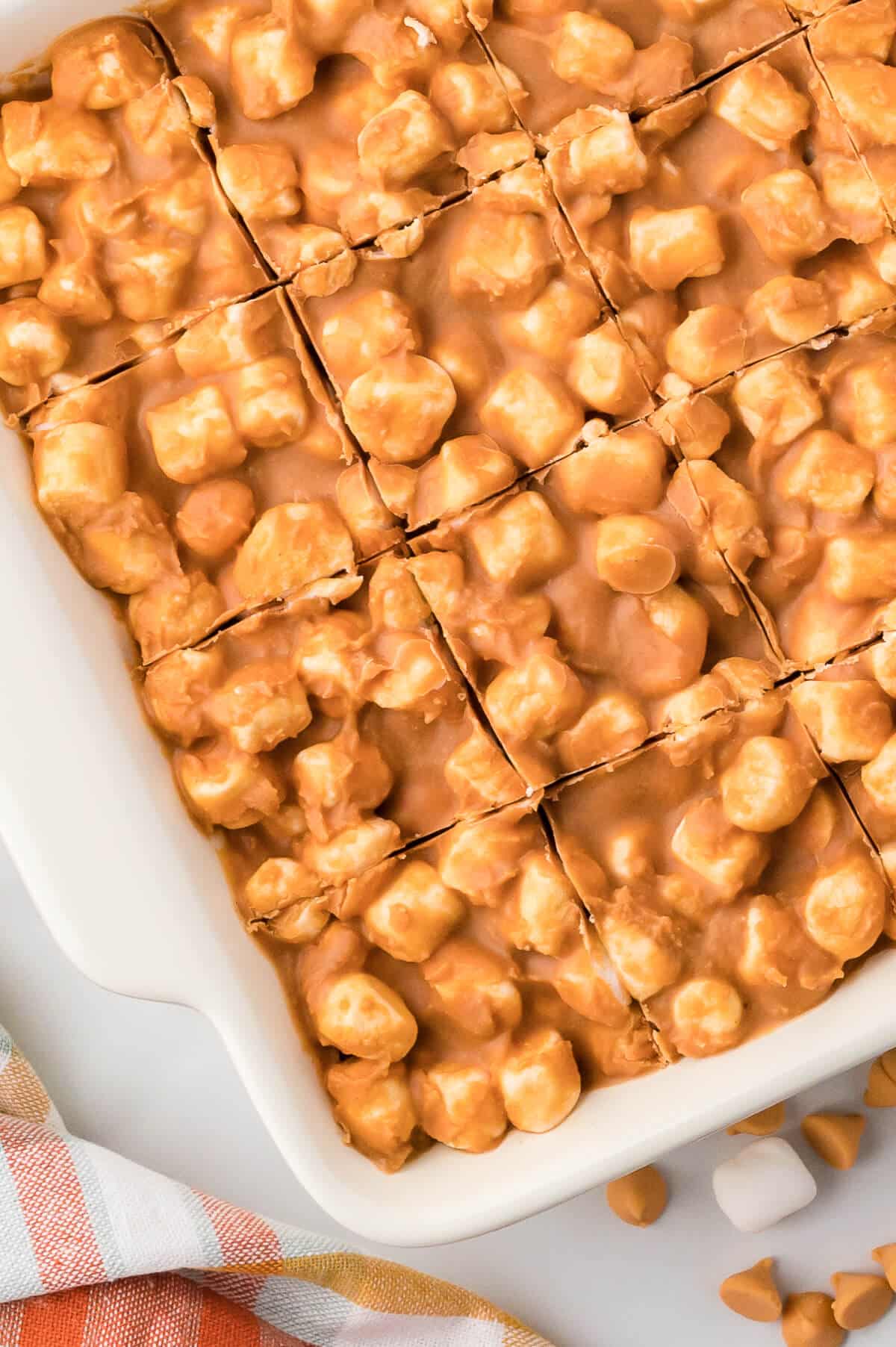 A pan of marshmallow bars with cut marks.