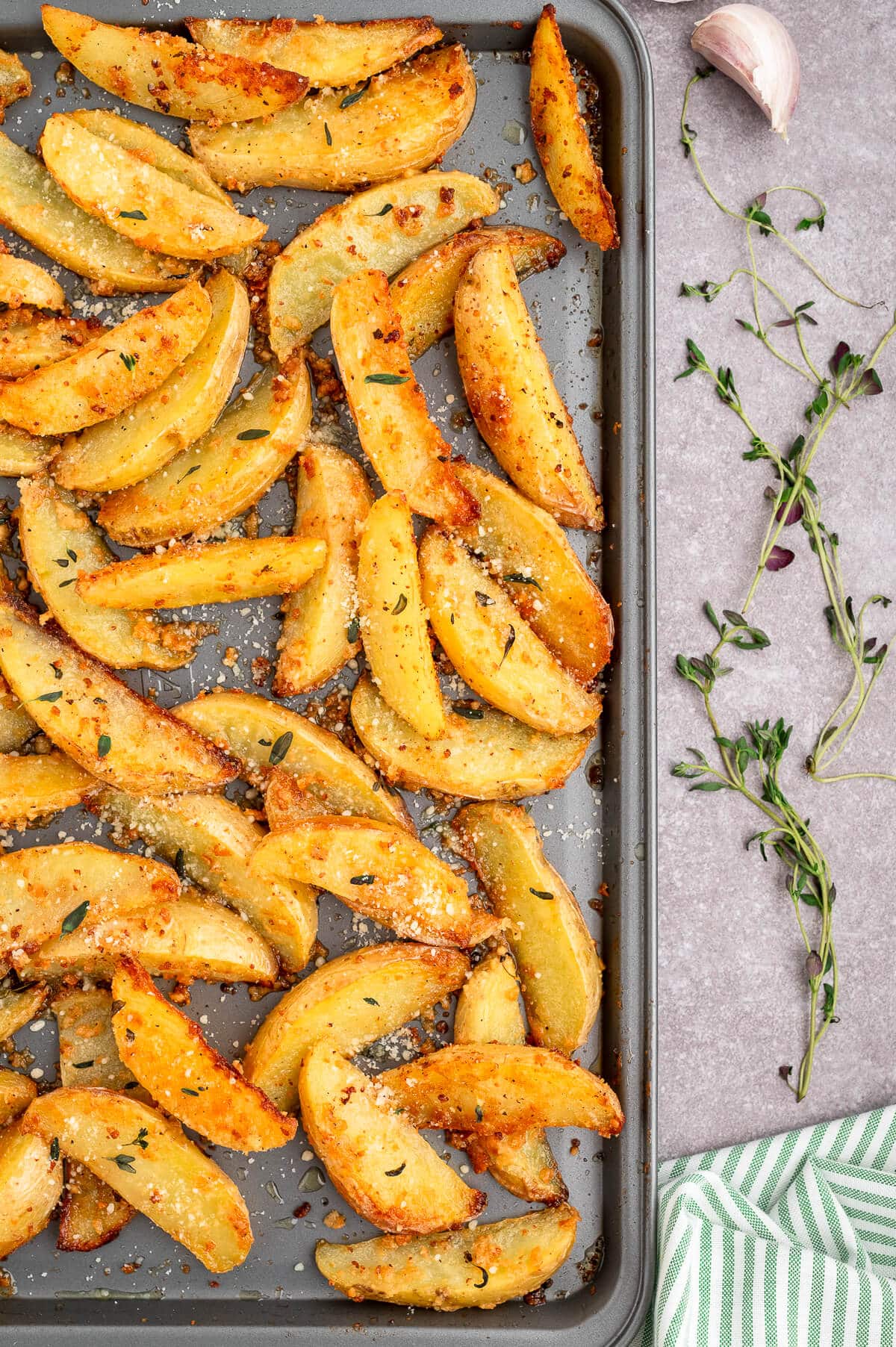 Parmesan thyme roasted potatoes on a baking sheet.