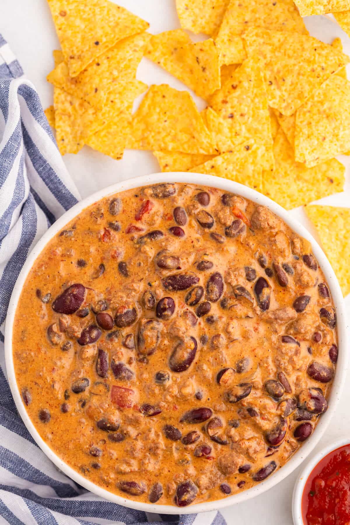 A bowl of slow cooker chili cheese dip.