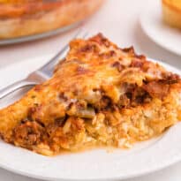 Spaghetti pie slice on a plate.