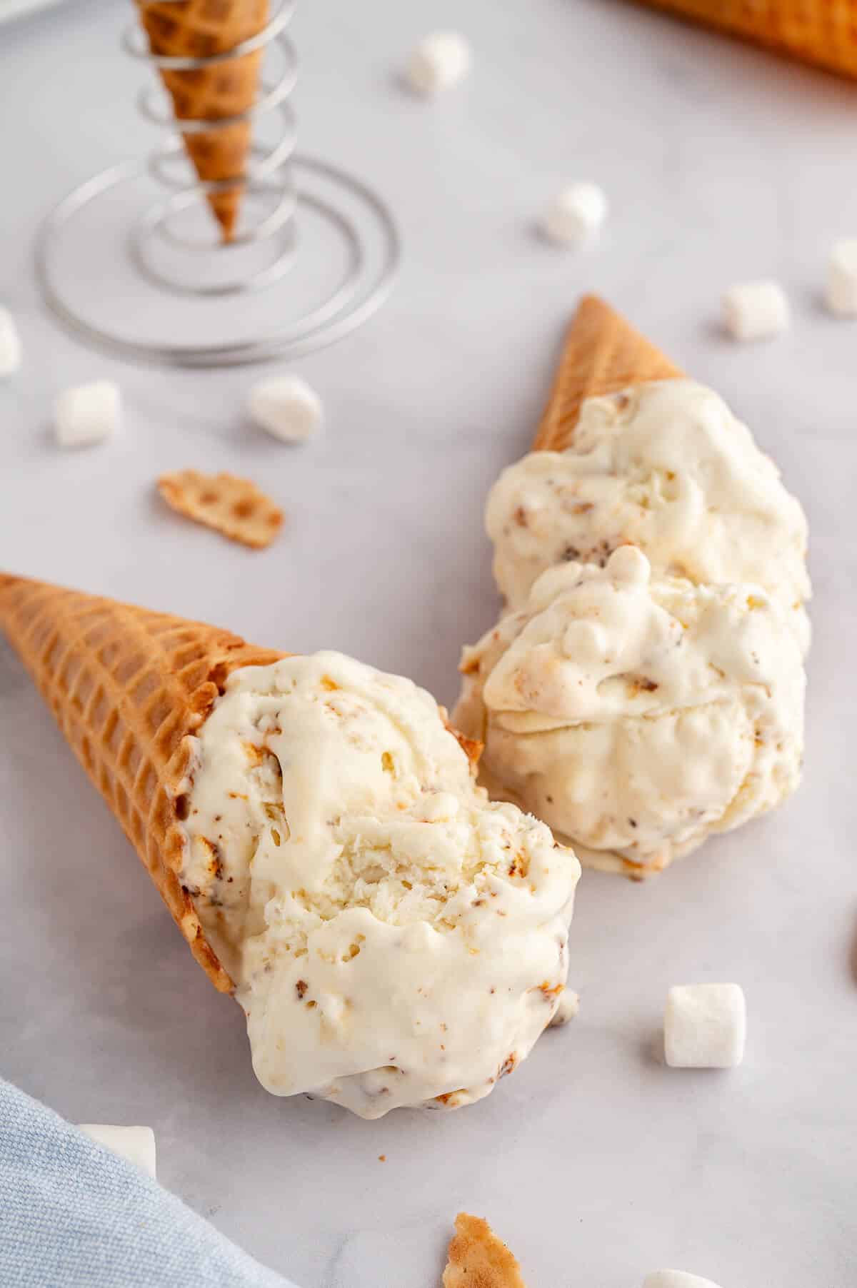 Two ice cream cones with toasted marshmallow ice cream.