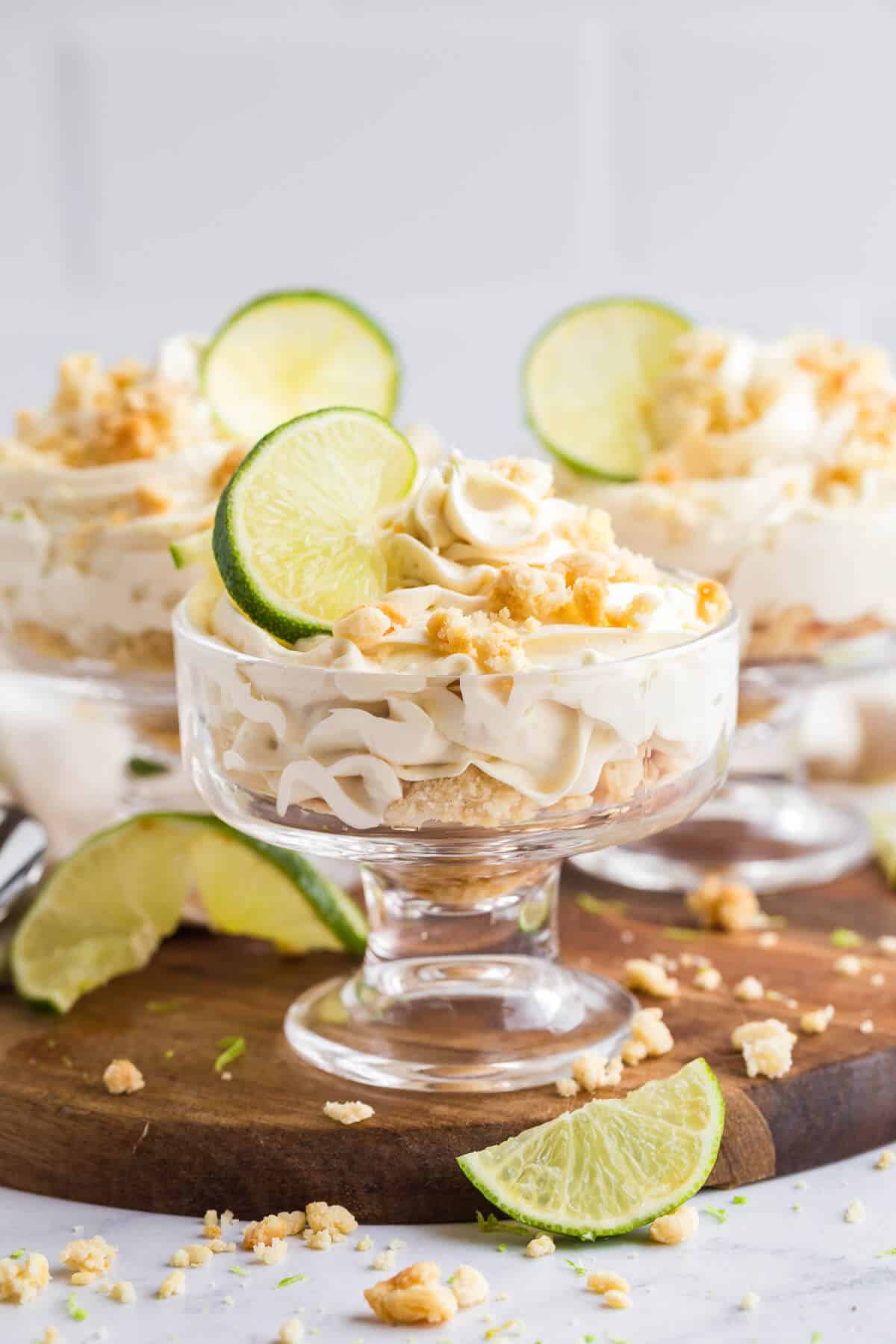 A lime cheesecake parfait on a wooden board.