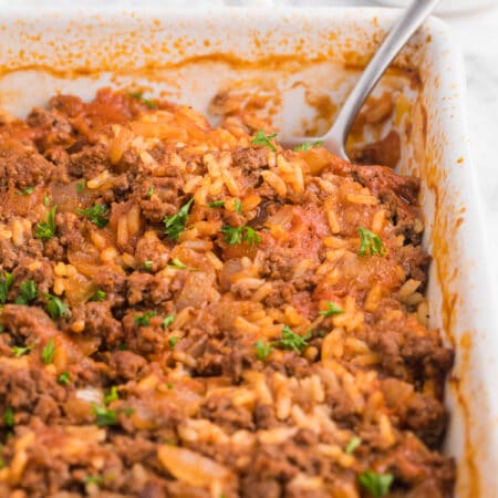 The recipe in a casserole dish with a serving spoon.