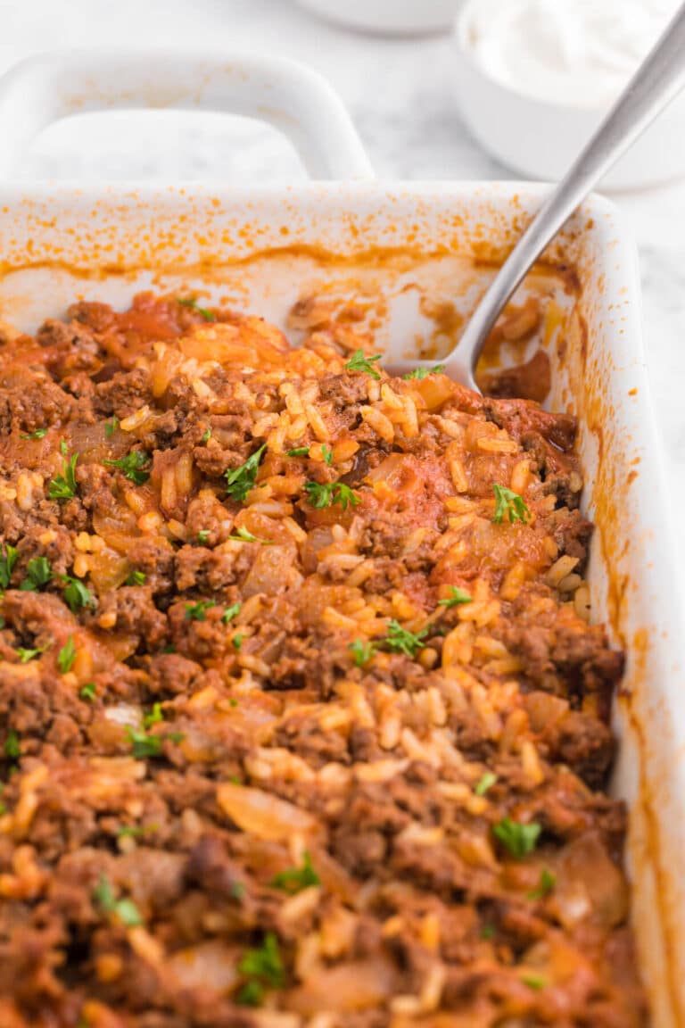 The recipe in a casserole dish with a serving spoon.