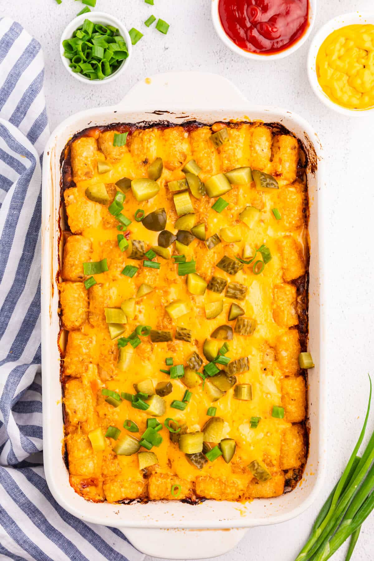 Cheeseburger tater tot casserole in a white casserole dish.