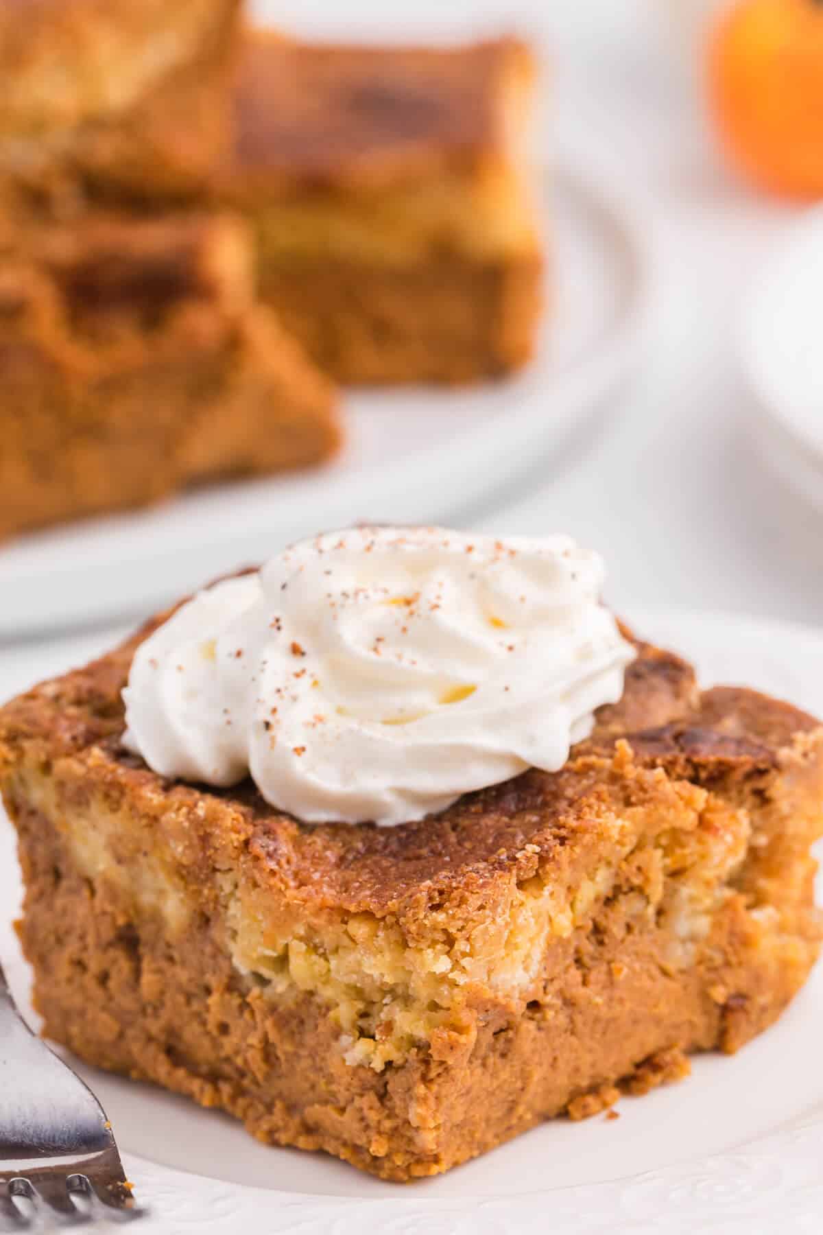 A slice of pumpkin dump cake on a plate.